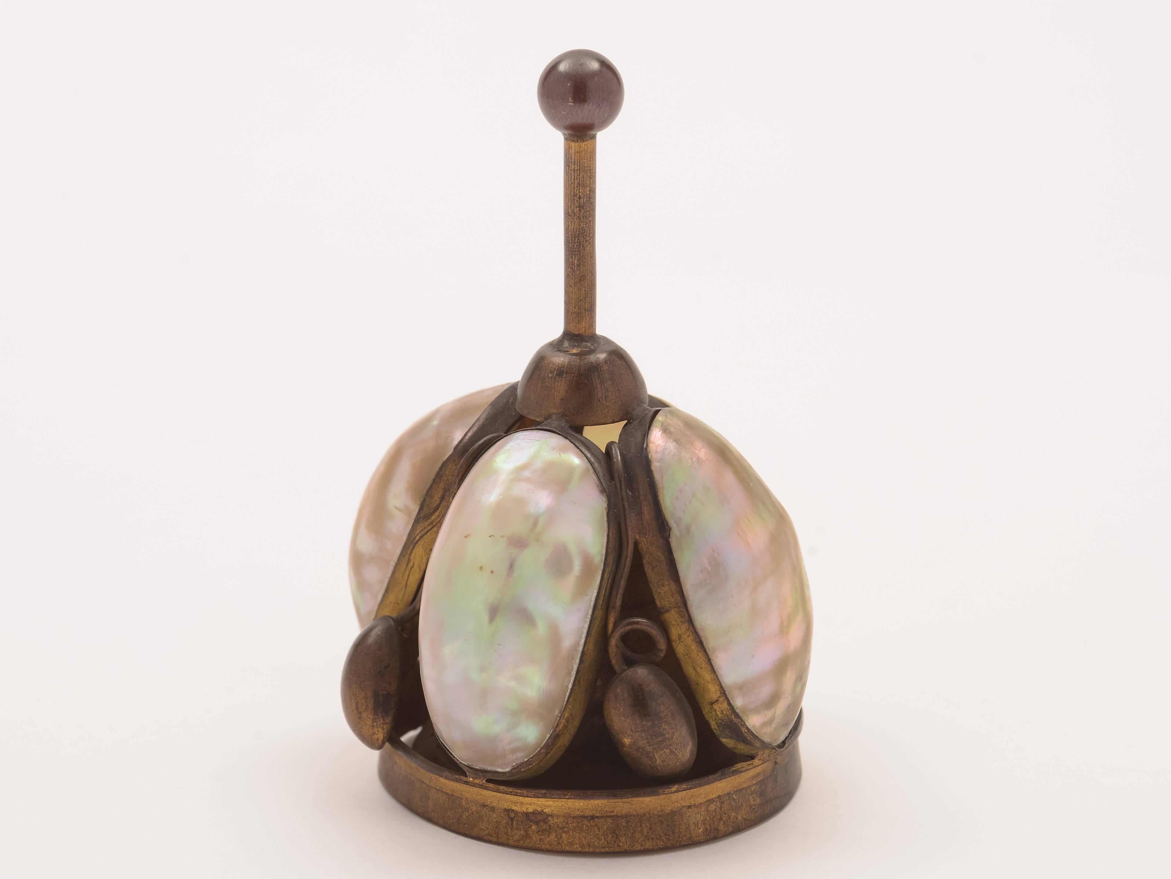 A lovely French brass table bell with four polished shells inset in brass gilt (has a nice ring to it), circa 1900.

Measurements:
Height 3 1/2