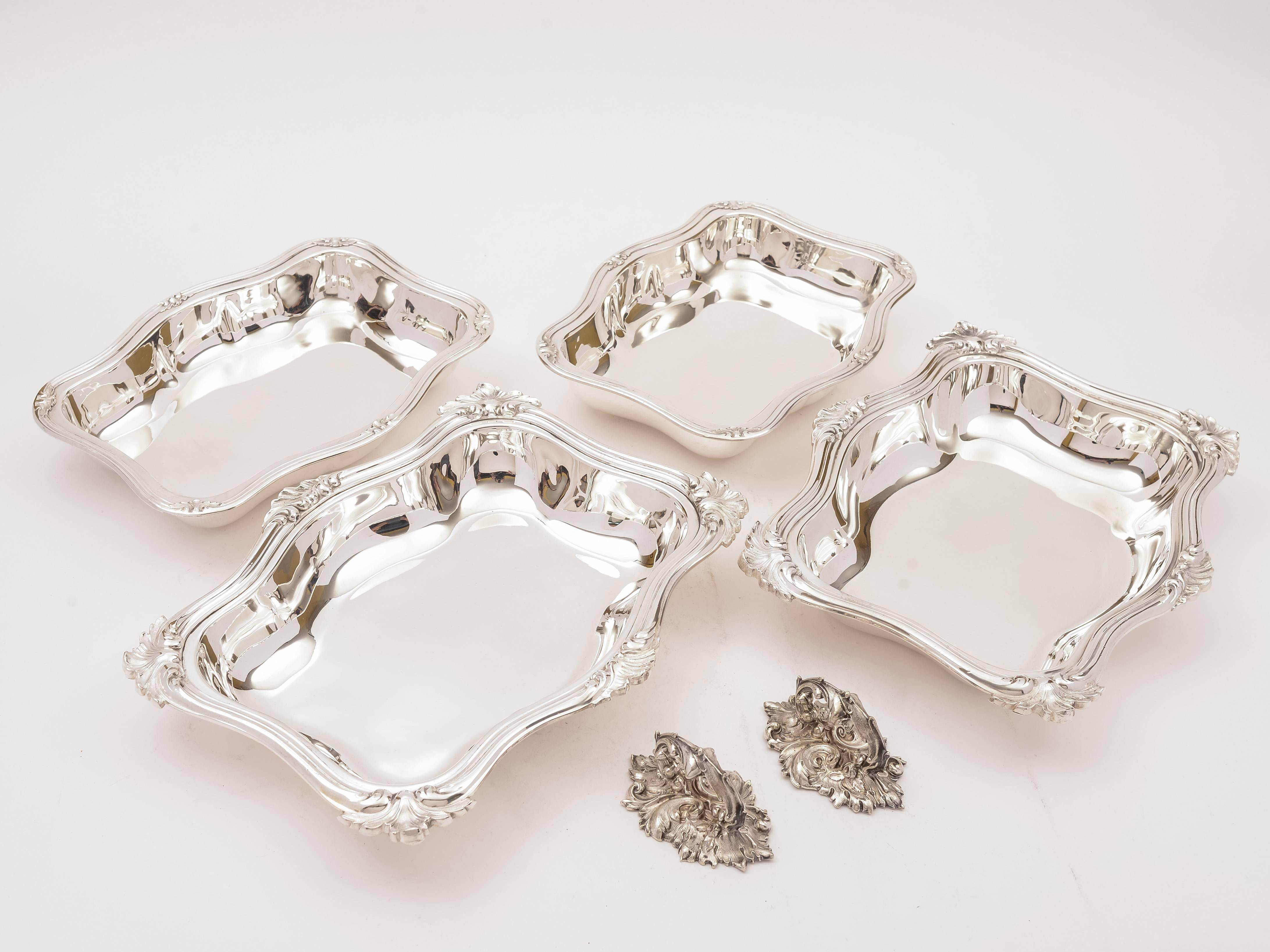 A good pair of English Victorian silver plated entree dishes, serpentine shaped with Rococo style decoration. Handles are detachable so that all four dishes can be used for serving. Made by the renowned maker, John Dixon & Co, London, circa