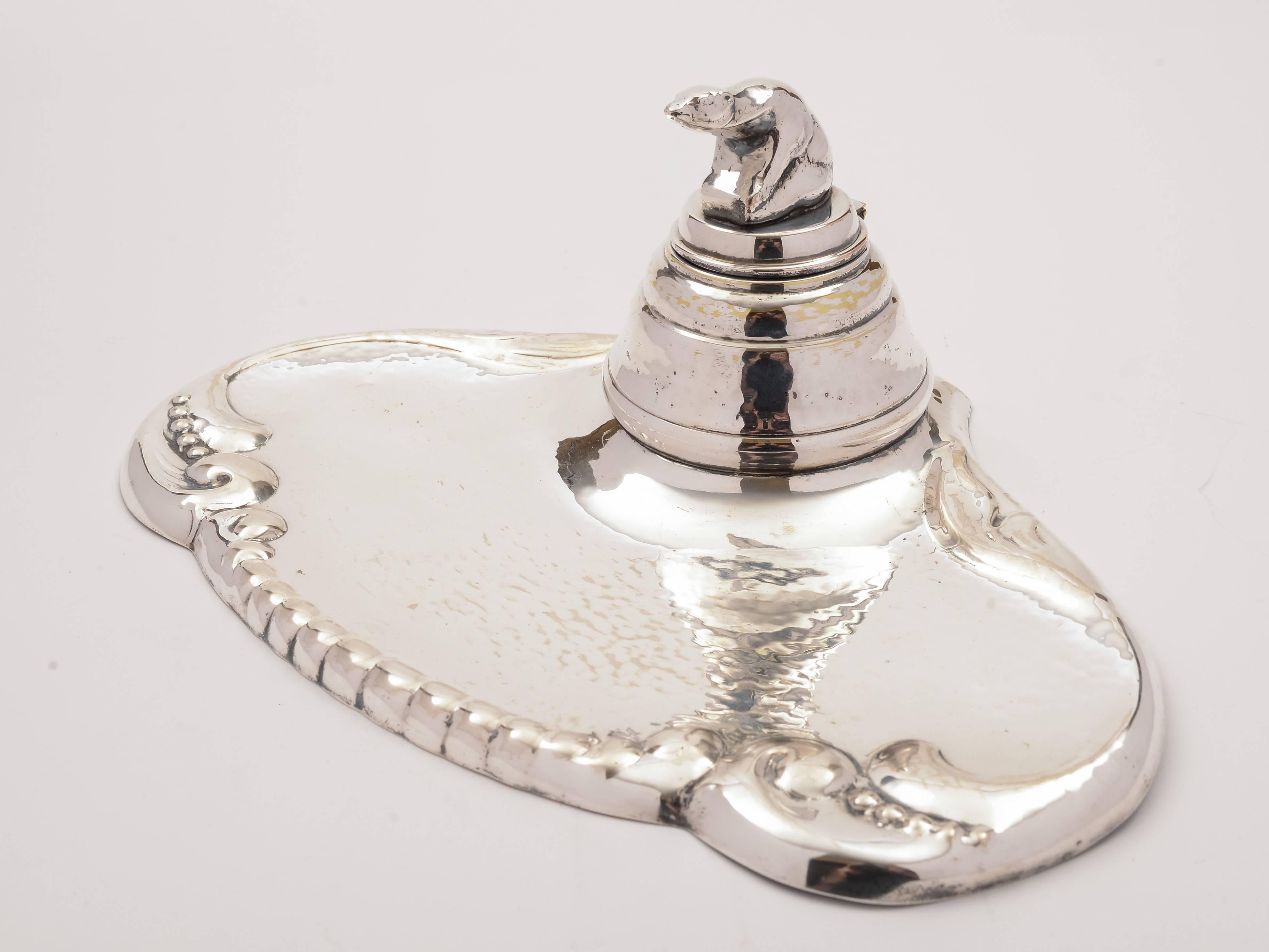 A lovely Nordic 20th century silver plated ink stand with polar bear finial to ink pot and embossed and hammered decoration to tray and internal removable glass liner, circa 1930.

Free worldwide delivery.

Measurements: 
Height: 4