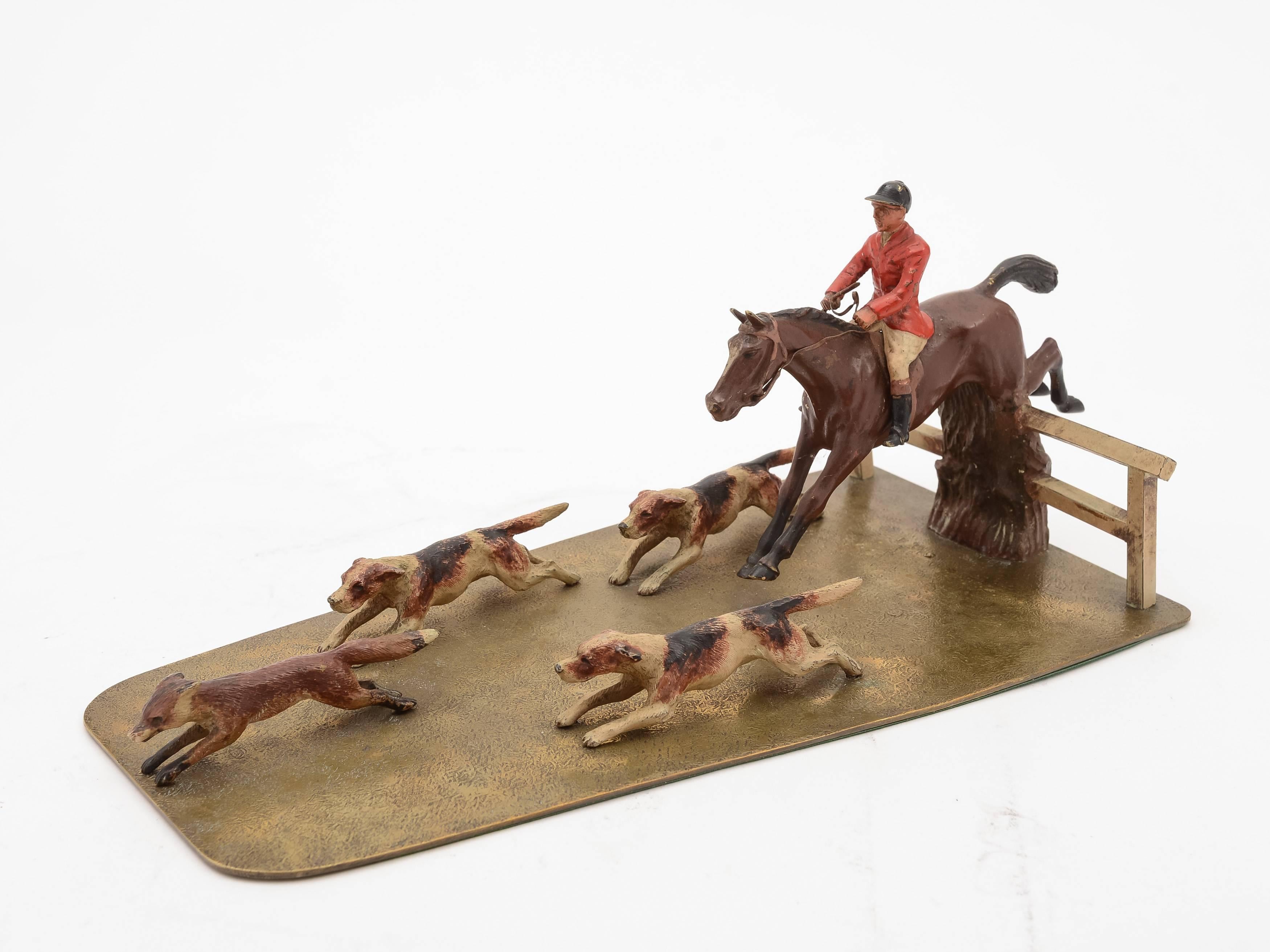 A fabulous European (probably Austrian: unmarked) cold painted, bronze/brass hunting desk ornament depicting huntsman taking a fence on a horse with his hounds chasing a fox, circa 1900.

Free worldwide delivery.

Measurements:
Height: 5 1/2