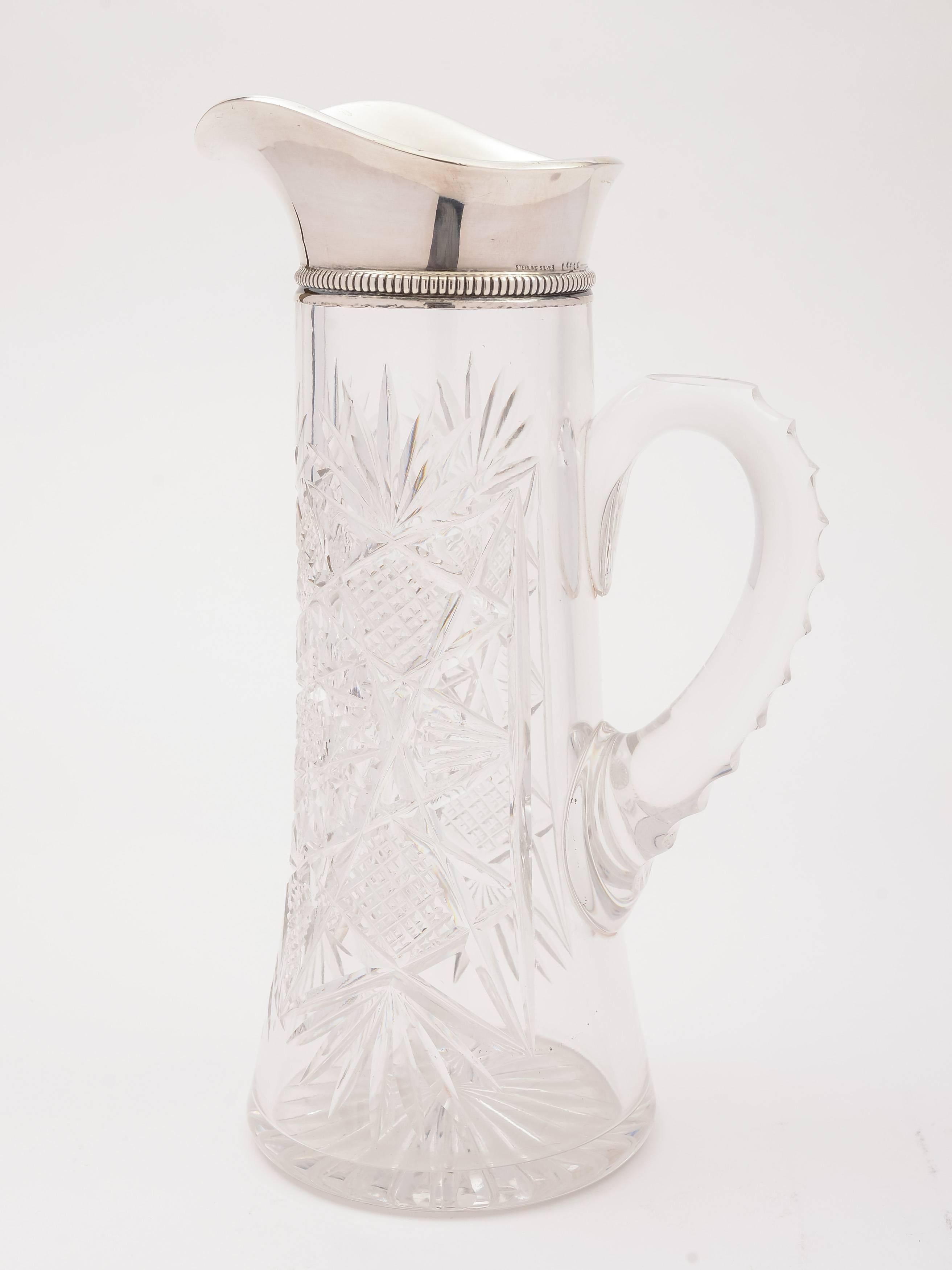 A nice American silver topped and cut-glass jug / pitcher. The top is marked sterling .925 with an English import mark for Birmingham, 1905. Has lovely cut-glass decoration, star cut base and solid glass handle.

Free worldwide