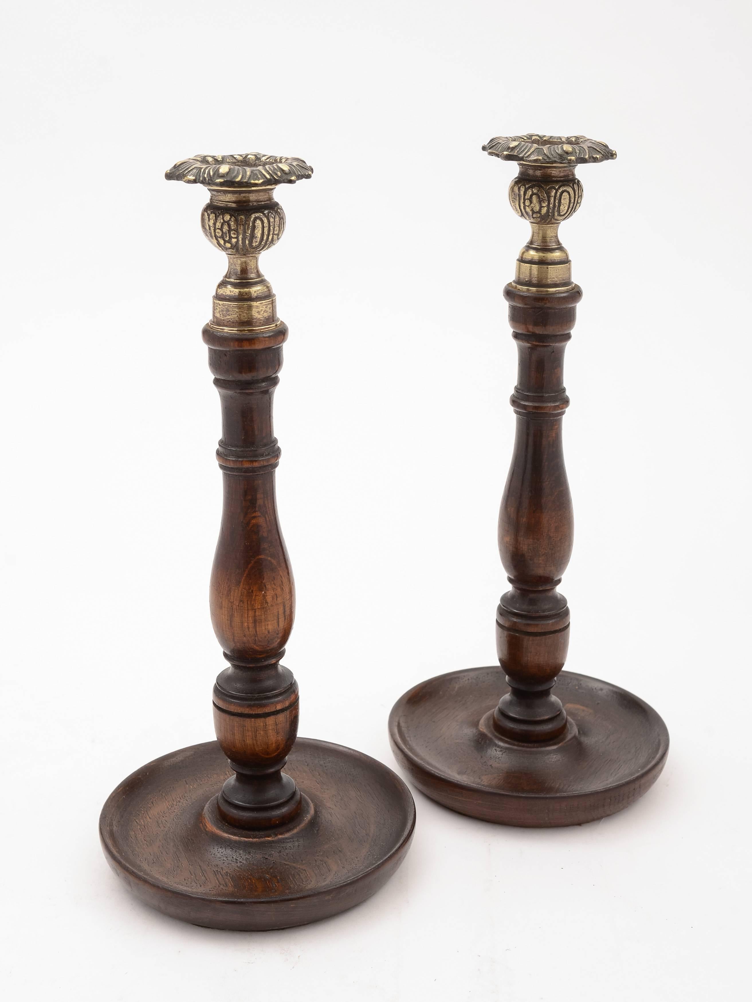 A good pair of English oak turned candlesticks with solid embossed brass tops and drip trays, circa 1920.

  

Measurements:
Height 11 1/2