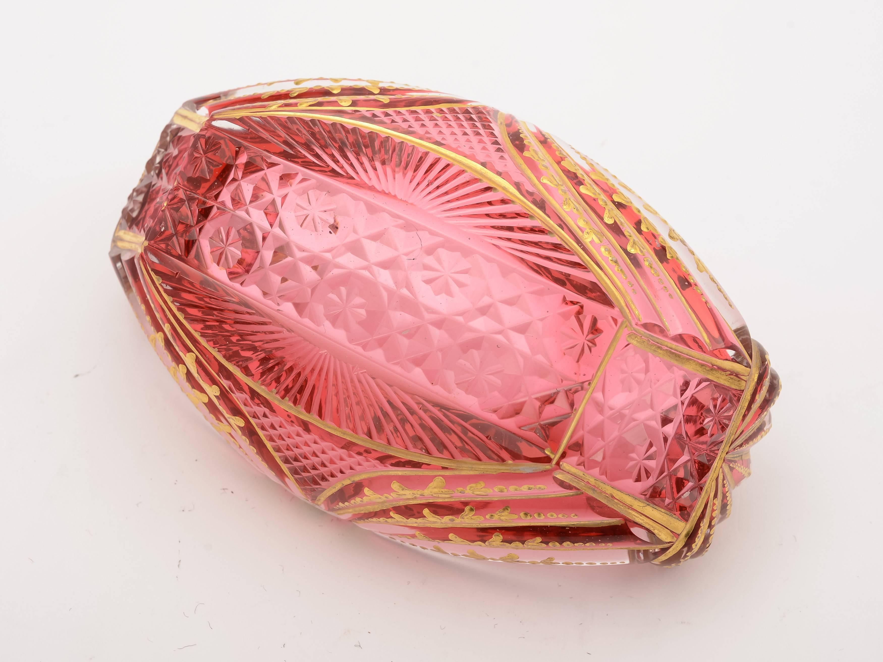 A fabulous English Regency cranberry glass, boat shaped bon bon dish with cut-glass and gold gilt decoration, circa 1830.

  

Measurements:
Height 2 3/4