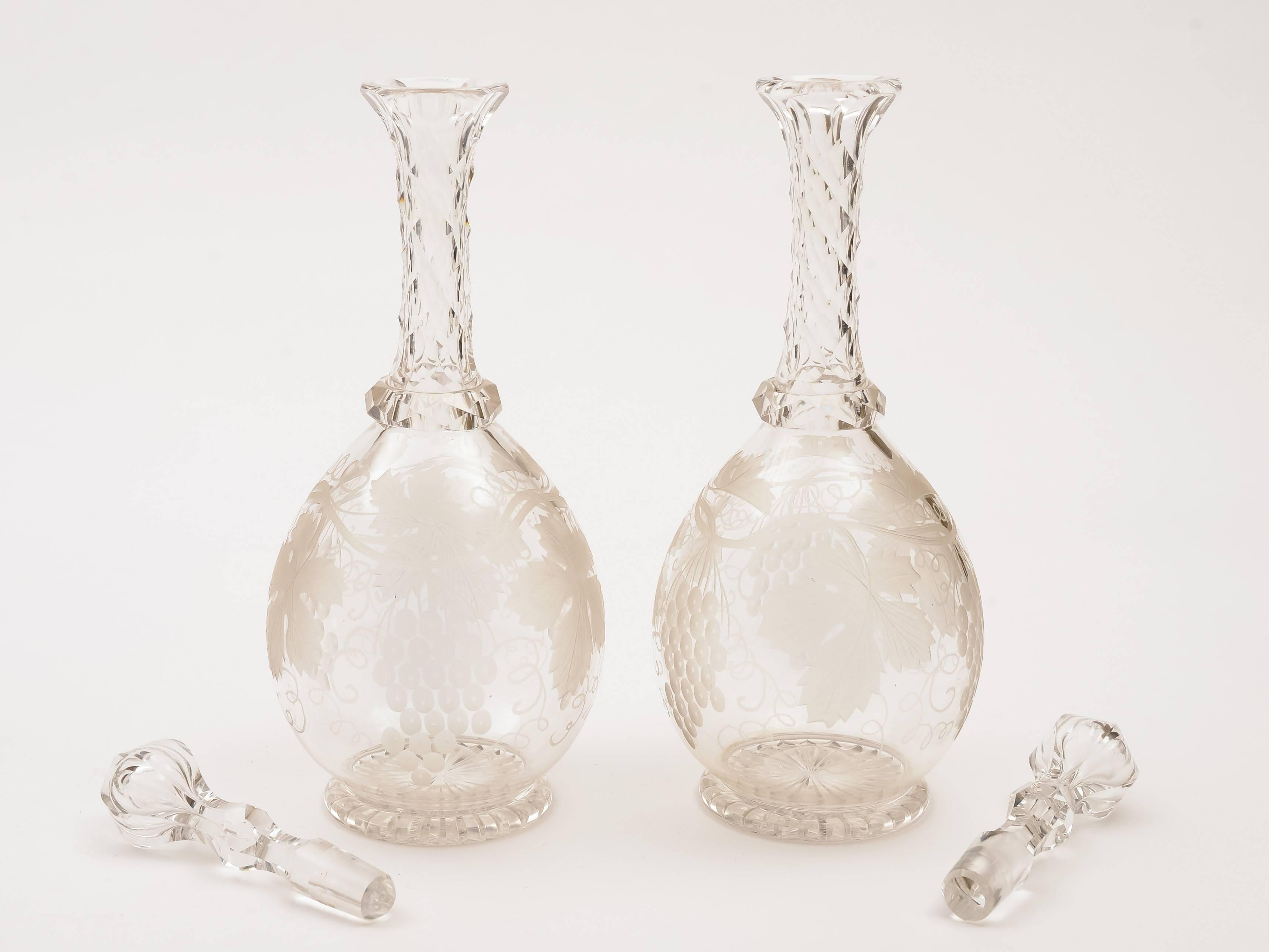 A beautiful English Edwardian pair of glass decanters with lovely etched grape and vine decoration to body, elegant and long, slender cut-glass necks and original stoppers with star cut bases, circa 1905.

Measurements:
Height 11