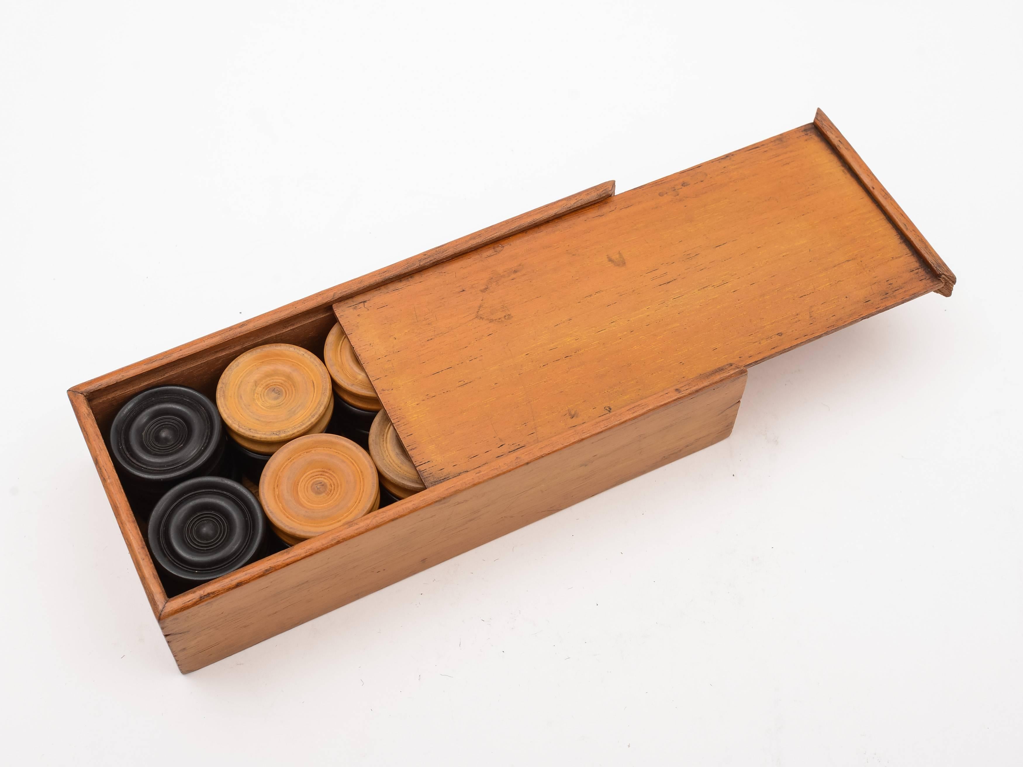 A good cased English Edwardian draughts/backgammon counters in ebony and boxwood and presented in original wooden box with sliding lid, circa 1905.

 

Measurements:
Counter height 1/2