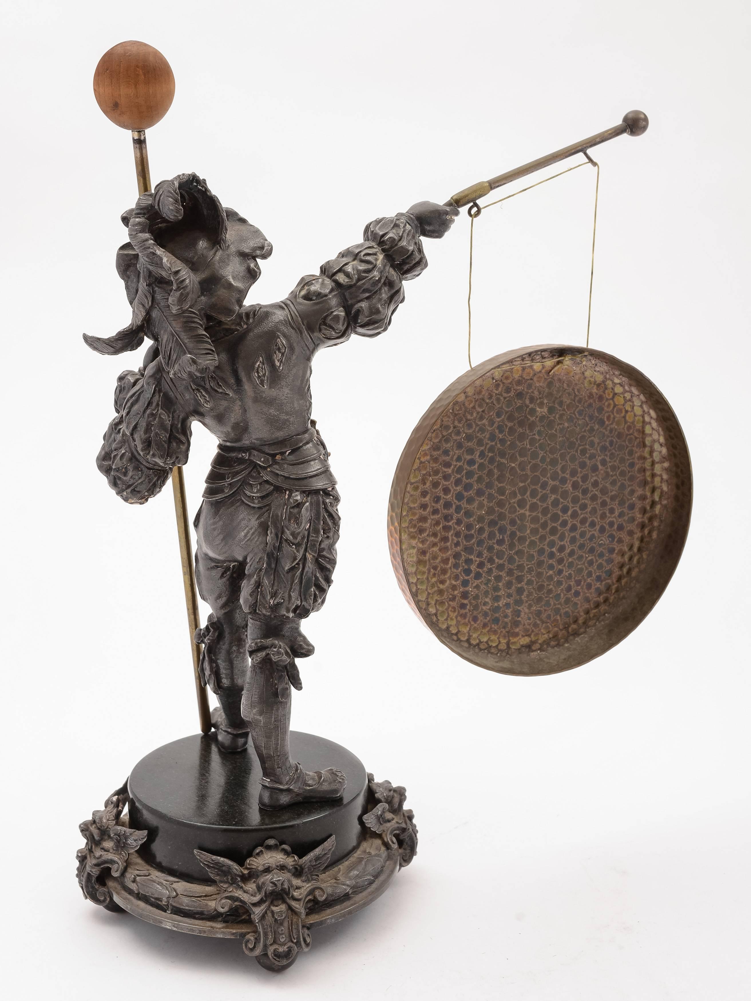 A fabulous WMF German spelter novelty dinner gong depicting military man in elaborate period costume holding brass striker and standing on ornate base with brass gong attached to gun, circa 1900. Has WMF mark to base.

 

Measurements:
Height