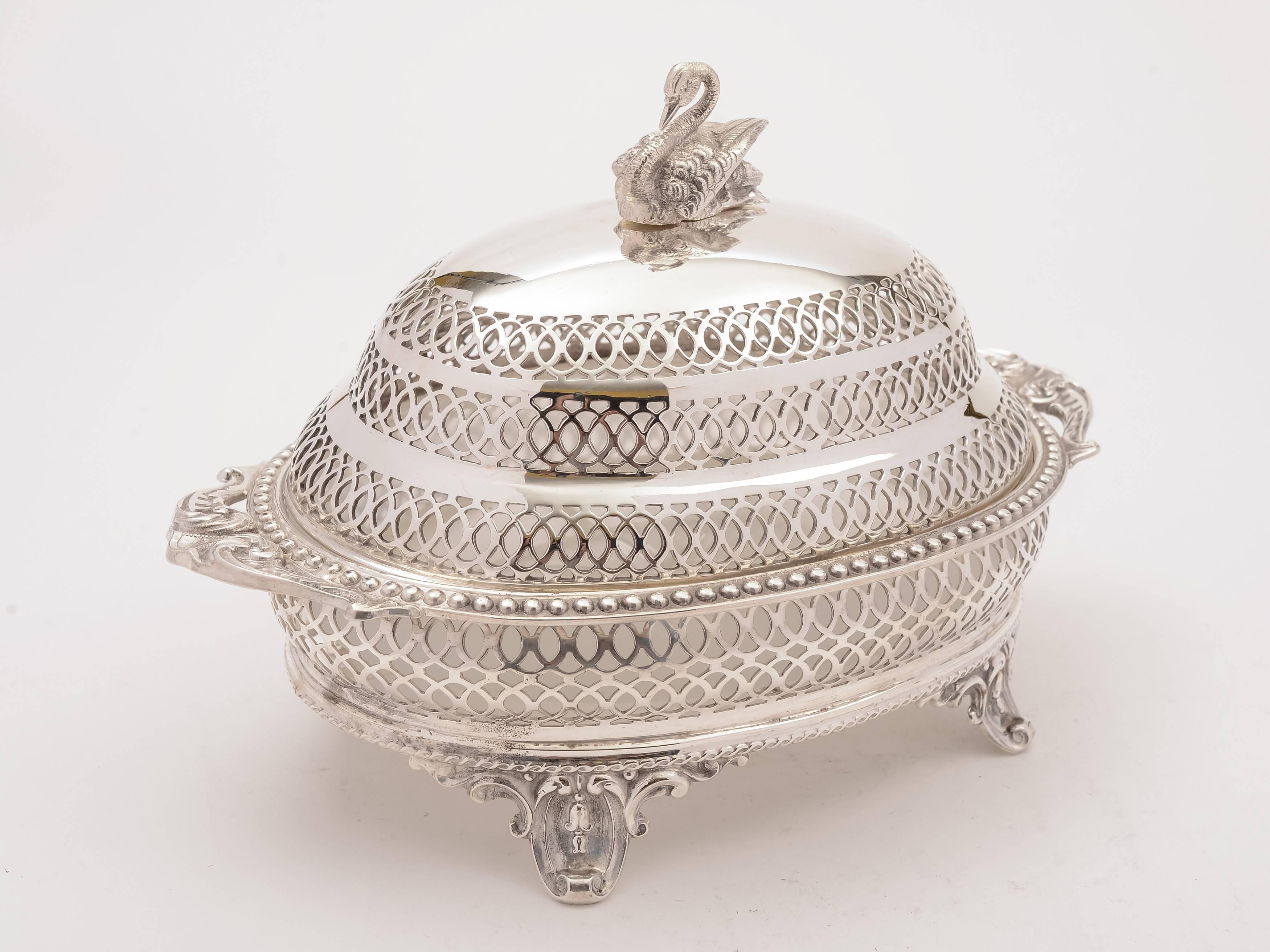 A superb English Victorian silver plated butter dish with frosted glass liner which has a star cut base, pierced decoration to body, swan finial and stands on four scroll feet, circa 1890.

 

Measurements:
Height: 6