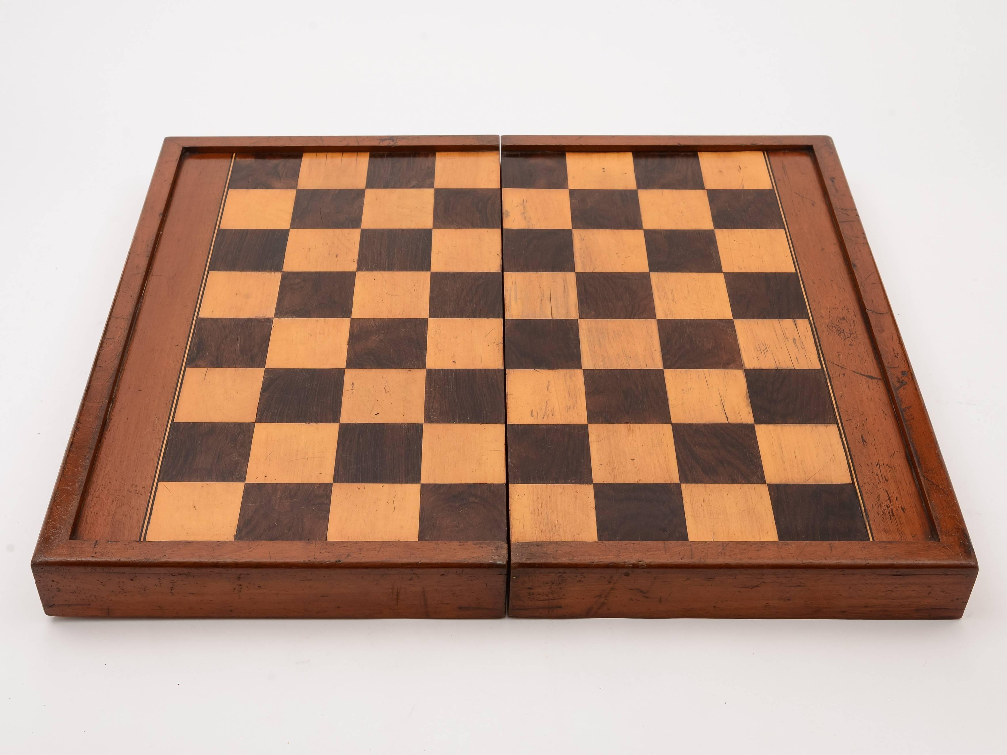 A good sized English Victorian mahogany chess and backgammon games box with rosewood, boxwood and ebony detailing to either side. The box opens to reveal the backgammon board with the chess board on the opposite side, circa