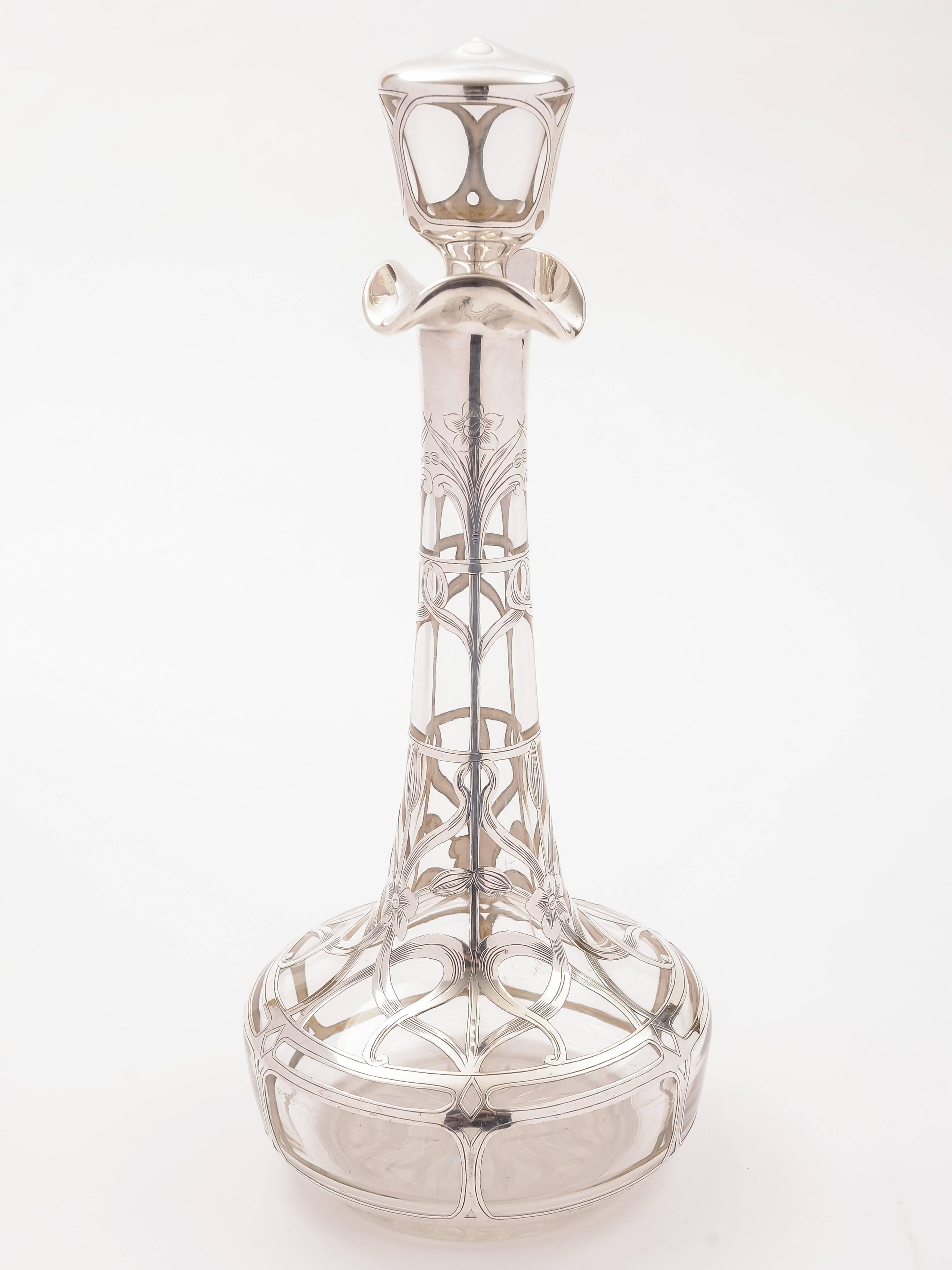A fabulous American Art Nouveau silver overlay glass decanter, marked sterling silver with original matching stopper and star cut base. circa 1900.

 

Measurements: 
Height: 12