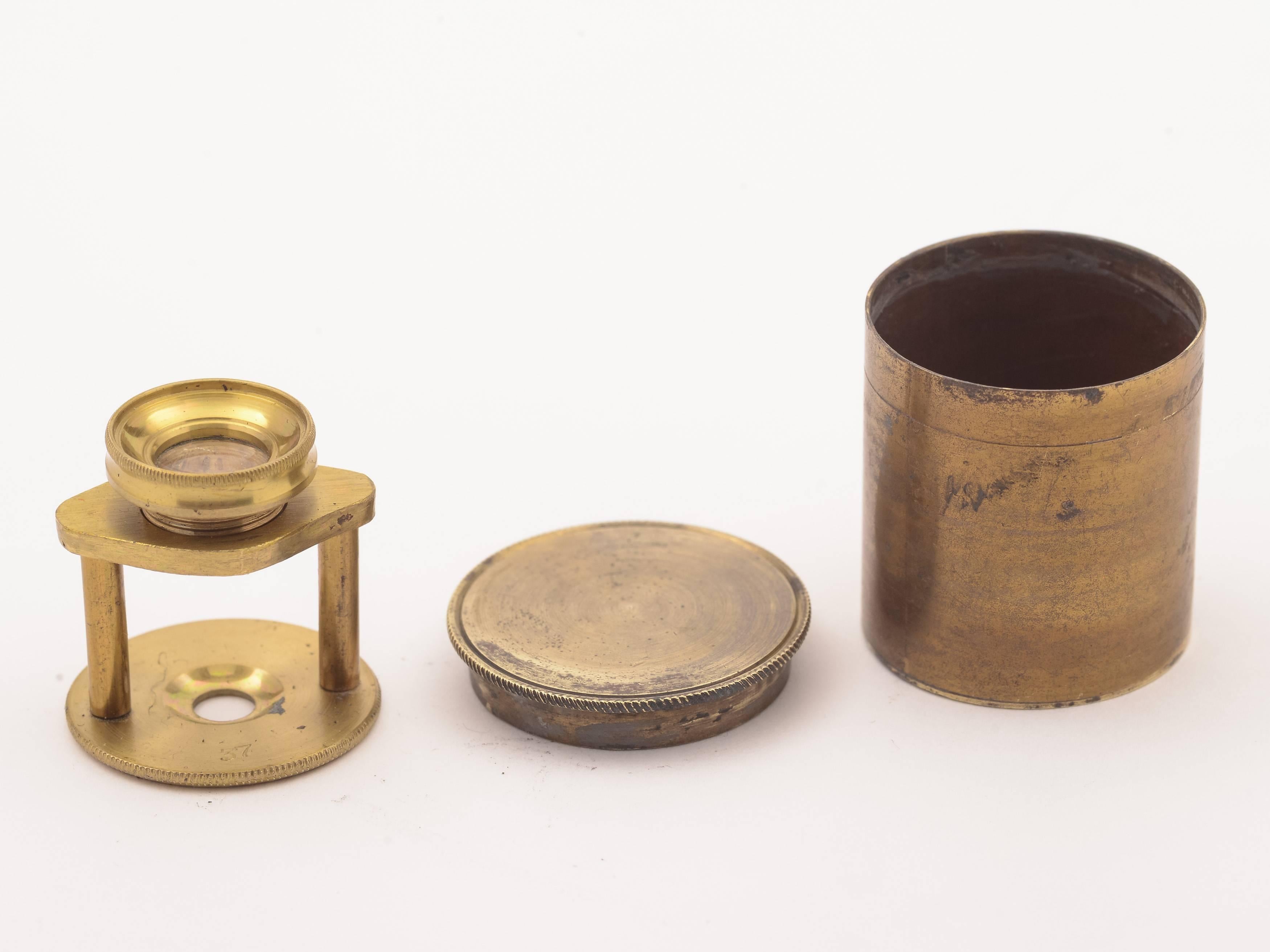 A nice English brass pocket microscope/magnifier in cylindrical protective box with adjustable screw-top lens, circa 1880.

Measurements:
Diameter across base: 3/4