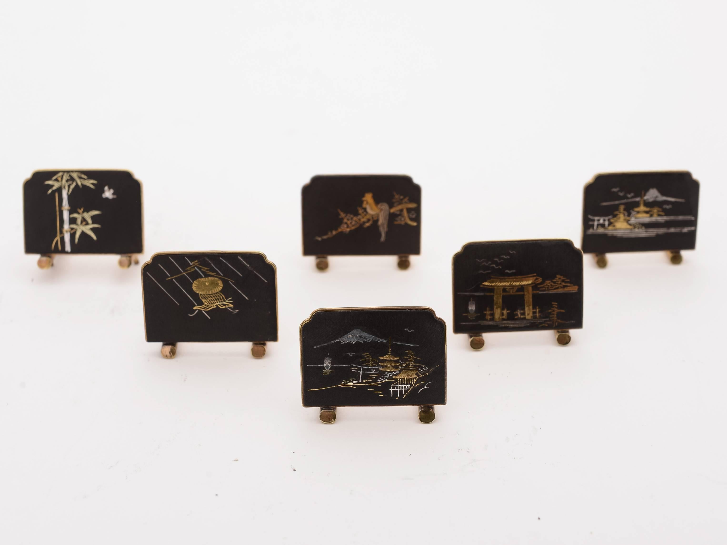 A stunning set of six Japanese Komai-Style brass menu holders with detailed scenes to the front of each in gold and silver, circa 1920.

Free worldwide delivery. 

Measurements:
Height: 1