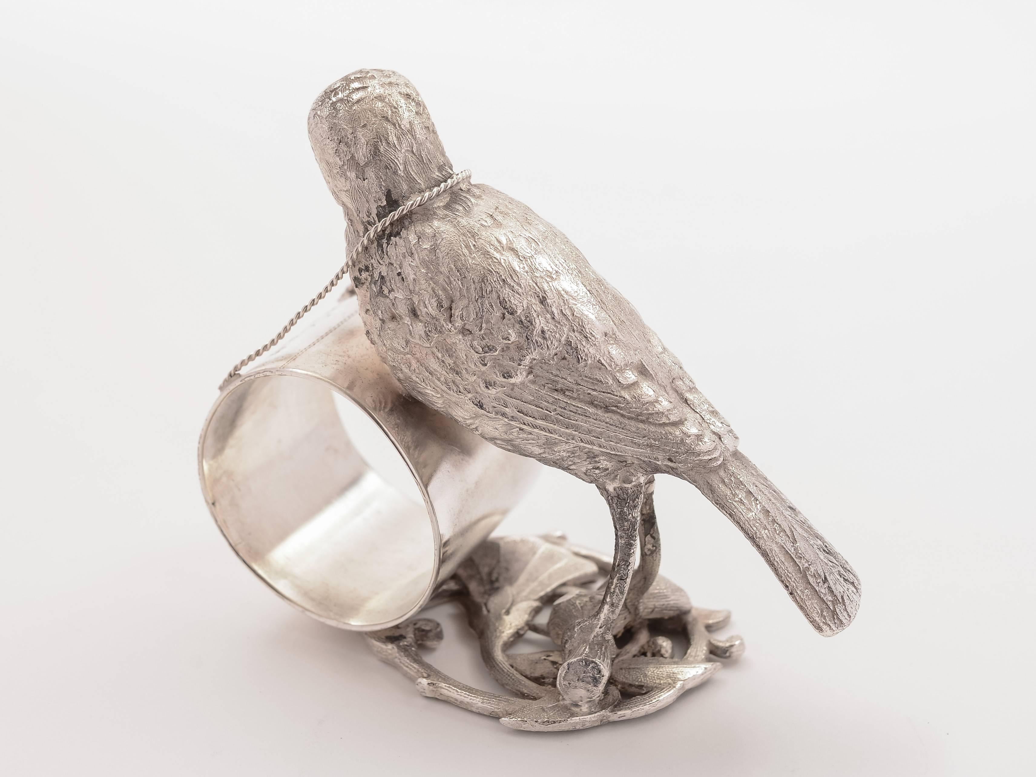 A nice American silver plated novelty napkin ring with nicely modelled bird standing on branch with napkin holder on a chain around its' neck, circa 1900.

Free worldwide delivery. 

Measurements:
Height: 3 1/2