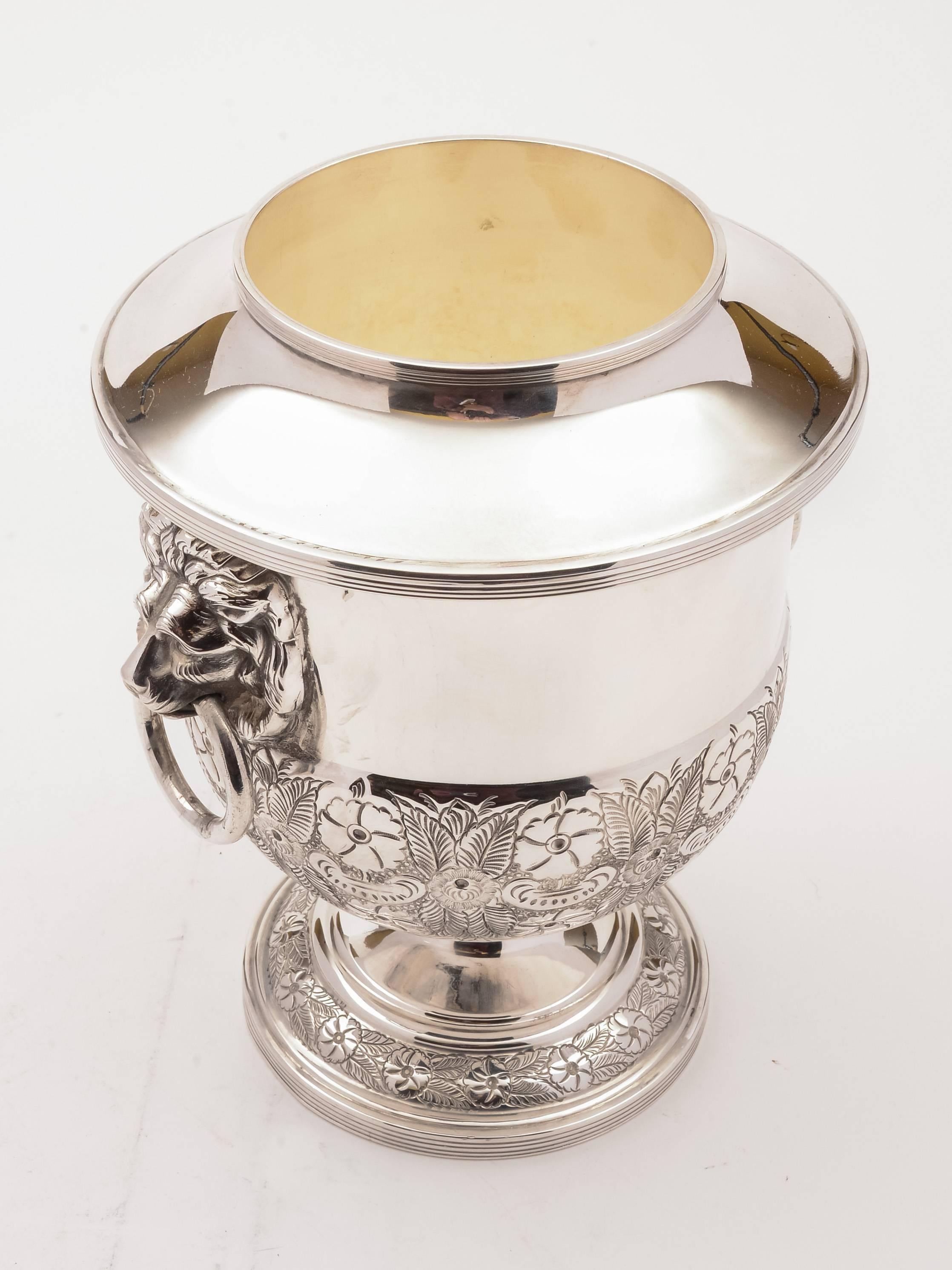 A fabulous English silver plated champagne/wine ice bucket with lion head handles and embossed decoration to base. Has removable liner which holds ice and allows for smaller wine bottles to be used. Circa 1920.

FREE worldwide delivery.
