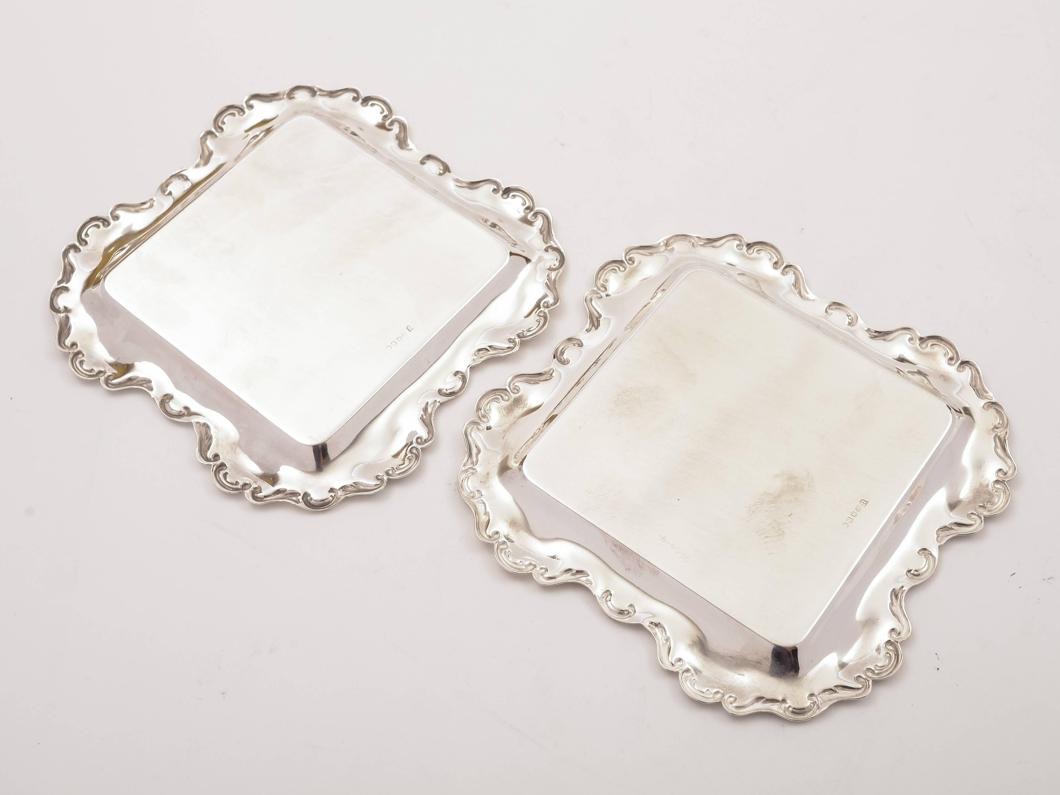 A nice pair of English Edwardian silver plated square card trays with embossed decoration to edges. Circa 1905.

FREE worldwide delivery. 

Measurements:
Height: 1/4" (approx 0.5cm)
Length & Width: 6 1/4" square (approx 15.5cm)
Total
