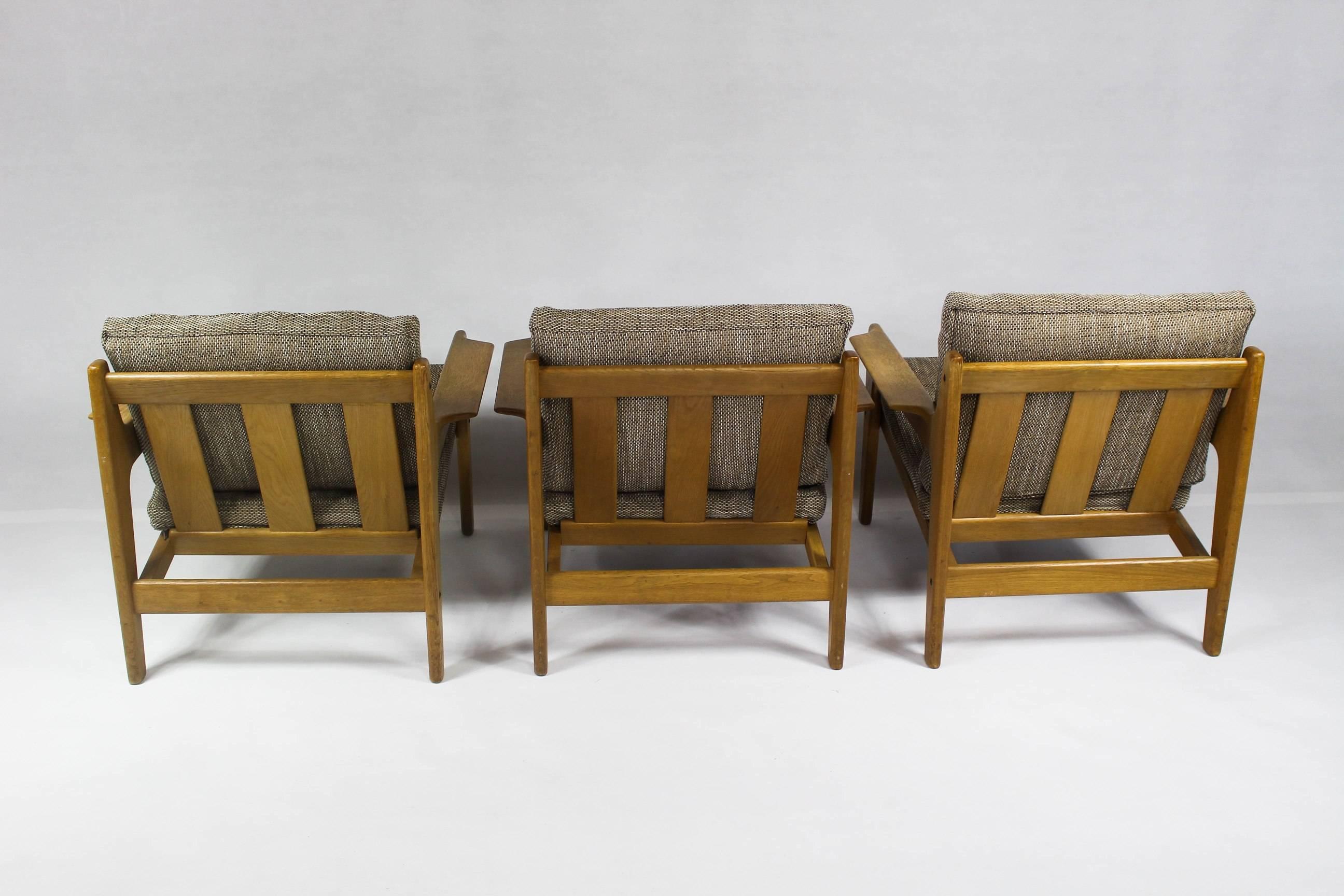 Price per one chair. We have Three in stock. 

The armchair was designed by Arne Wahl Iversen for Komfort in Denmark in the 1960s. It features a teak frame with original wool fabric cushions with zippers. They are in very good vintage condition.