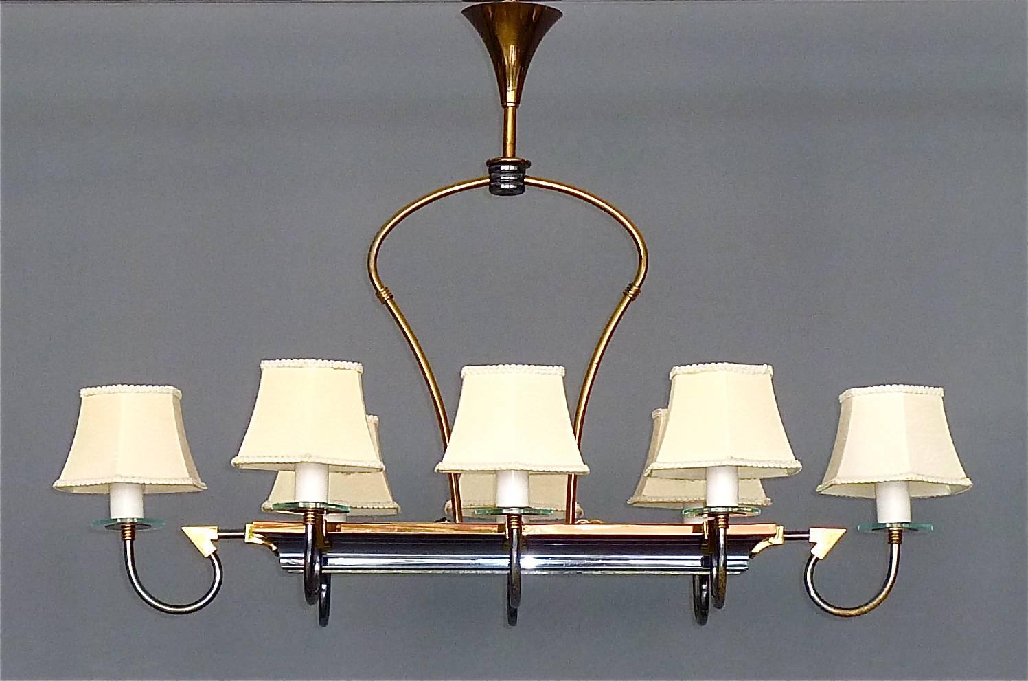 Fantastic large and fine Maison Arlus midcentury chandelier, France, circa 1940-1950. Eight-arm chandelier in gilt brass metal with blueish-grey enameled accents, glass discs finals and original nylon shades, center light in boat shape with textured