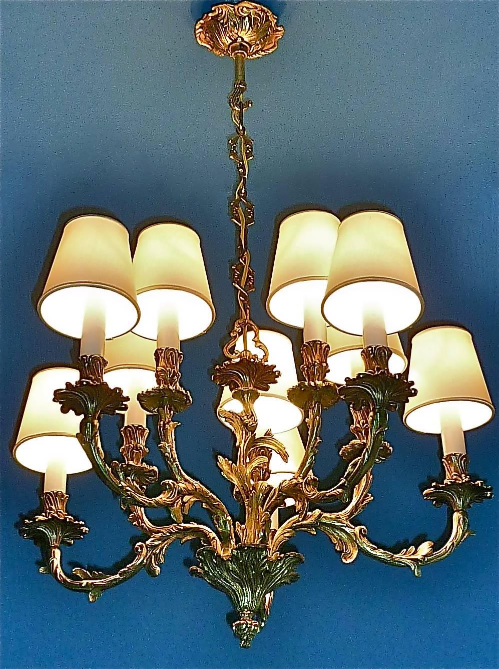 Precious French Baroque Rococo style ten-light chandelier which can be dated to the second half of the 20th century and possibly made by Maison Bagues, Paris. The wonderful manufactured chandelier is made of gilt bronze. It has a width of 55 cm /