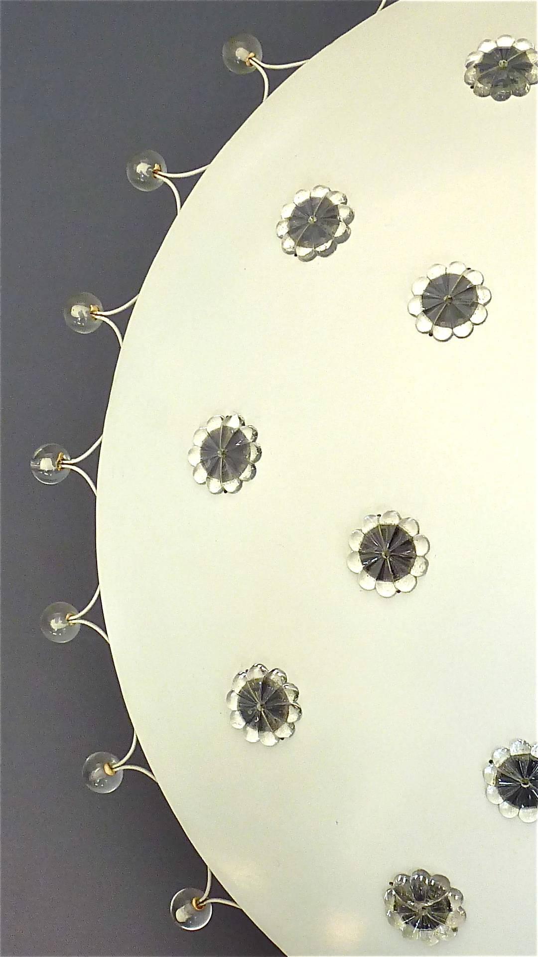 Large starburst ceiling light or chandelier in white enameled metal with patinated brass canopy, round glass flower applications and glass pearls, designed by Emil Stejnar and executed by Rupert Nikoll, Austria, 1950s. This large version of 50 cm /