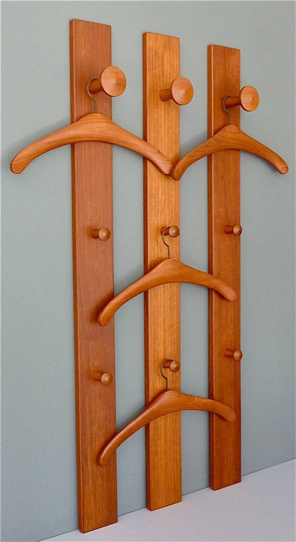 Fabulous set of three solid teak coat rack panels or wardrobe with four beautifully organic formed teak hangers designed and manufactured in the 1960s by Aksel Kjersgaard Odder in Denmark. The designs by master cabinet maker Aksel Kjersgaard have
