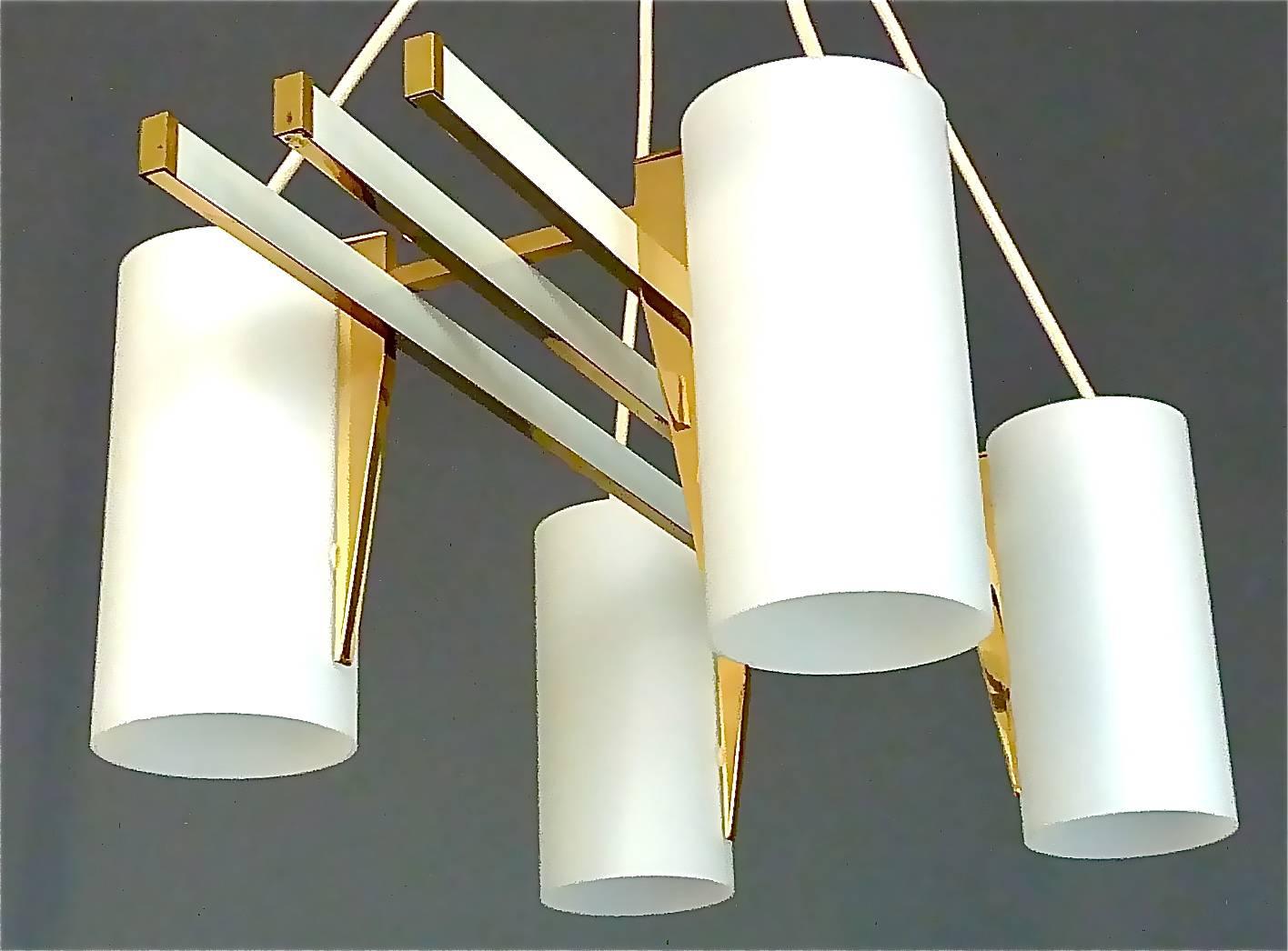Sculptural four-light chandelier in the style of Angelo Lelli for Arredoluce. It is made of a white enameled metal, brass metal construction with highly sophisticated brass details and four satin frosted glass tube shades. The awesome pendant lamp