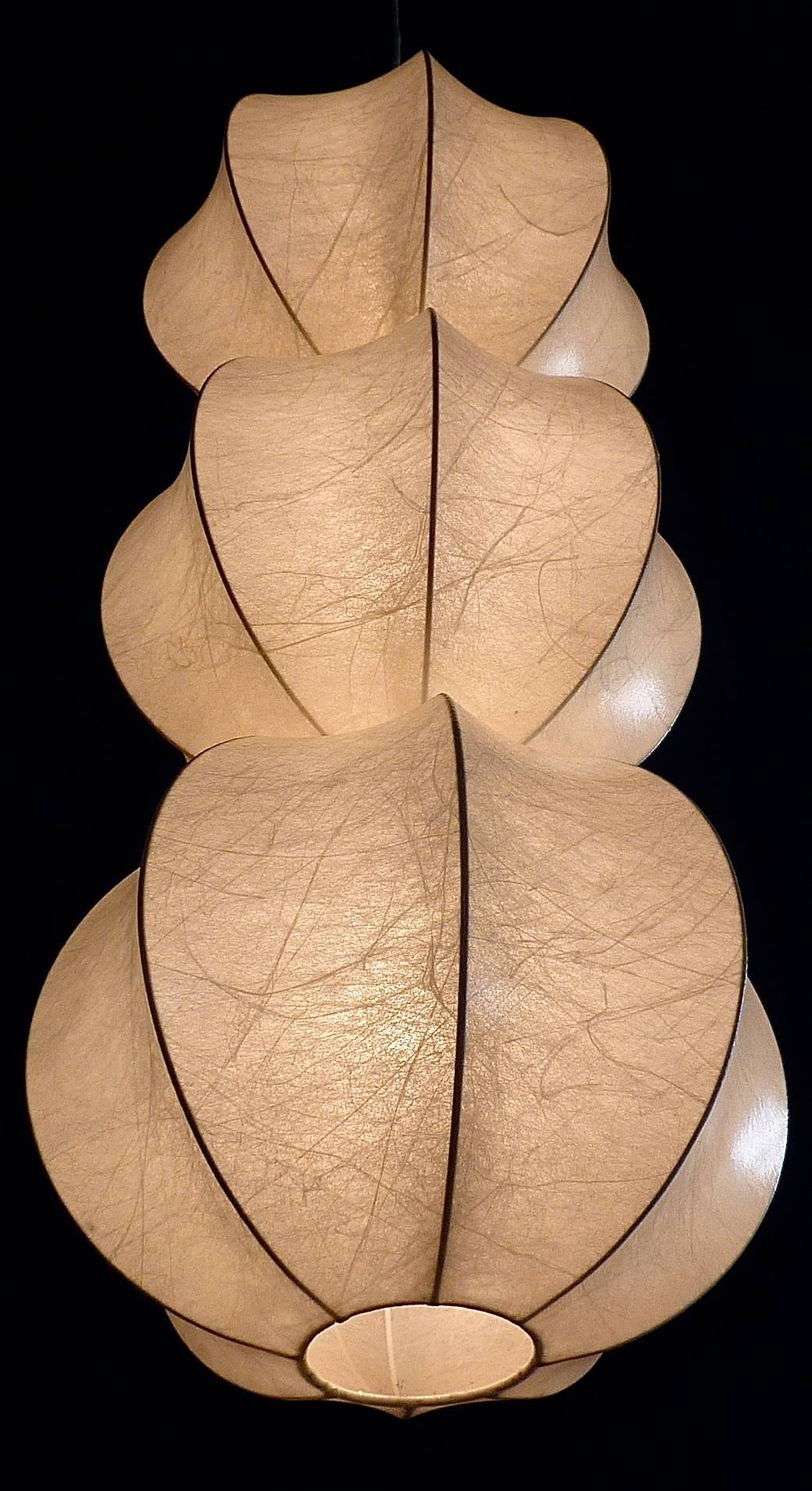 Rare and stunning Mid-Century large triple cocoon light weight pendant lamp circa 1955, possibly designed by Castiglioni for Flos, Italy. The body of one cocoon is approx. 30 cm / 11.81 inches tall, so all together about 90 cm / 35.43 inches. It has