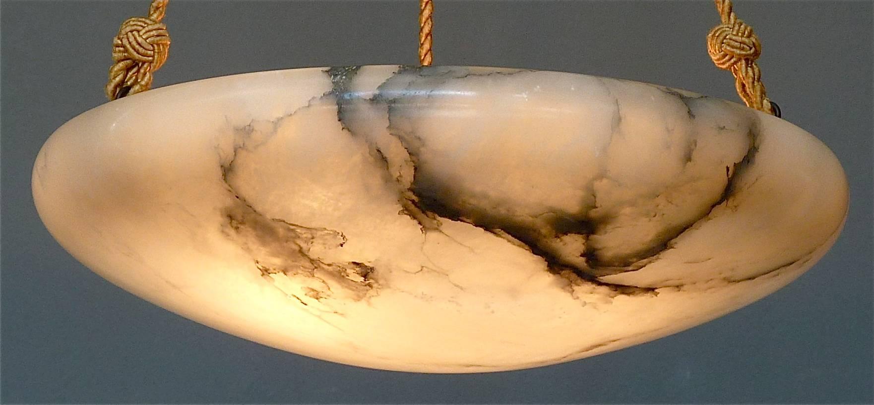 Beautiful classical and large French carved creamy white alabaster chandelier or light fixture with charcoal mineral veining from the Art Nouveau or Art Deco period, circa 1900 to 1920s. The high quality dome pendant has three patinated brass and