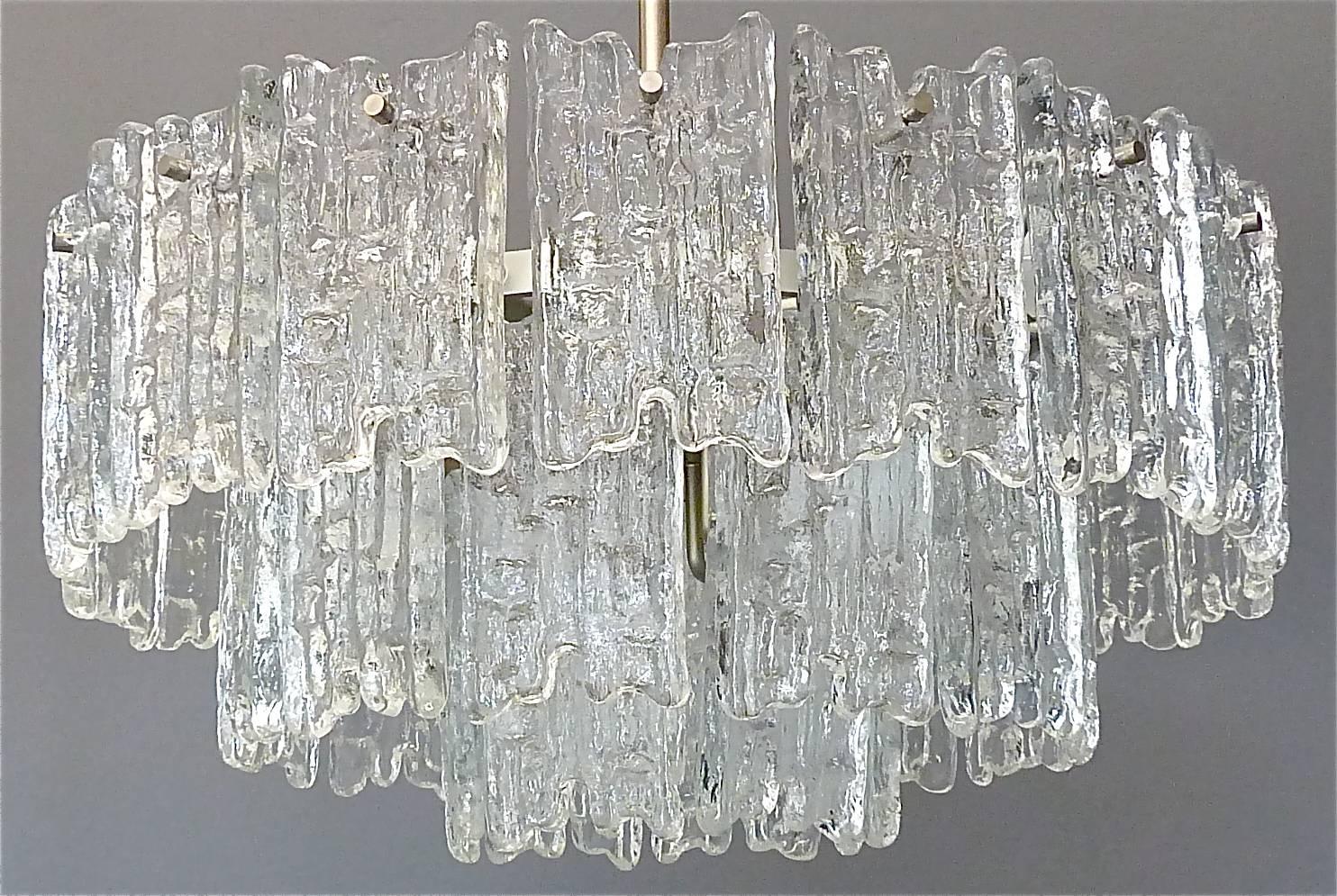Large and beautiful Kalmar Austria nickel-plated brass and textured ice glass chandelier executed in the 1950s. The modernist chandelier has three levels with 36 textured crystal ice glass panels and needs nine x E14 standard screw bulbs to