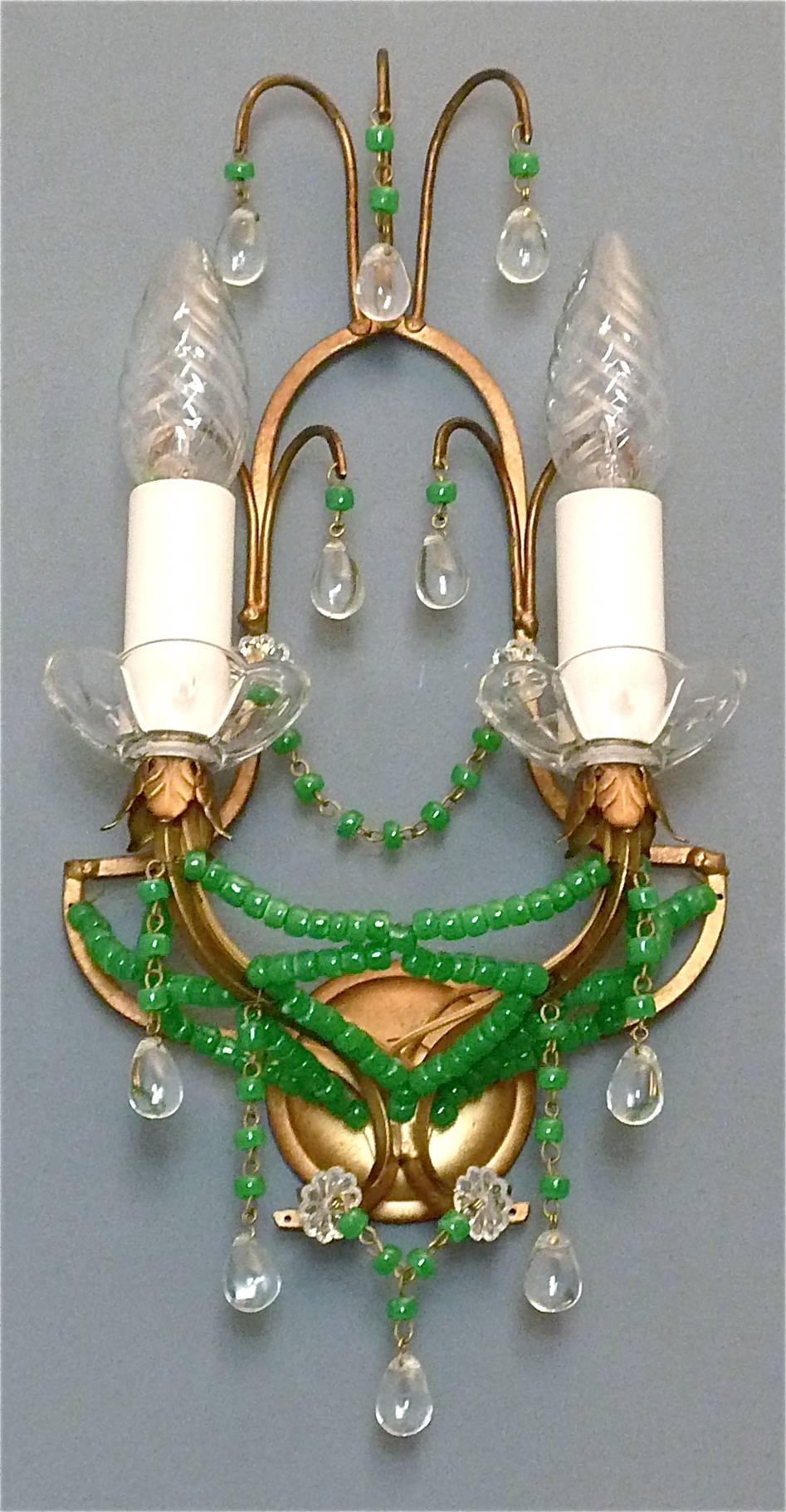 Lovely pair of Midcentury gilt metal and crystal glass wall sconces or wall lamps, Italy, circa 1970. Each wall light has jade green color Murano glass and crystal glass beads with a nice floral leaf gilt metal decoration. One sconce has a metal tag