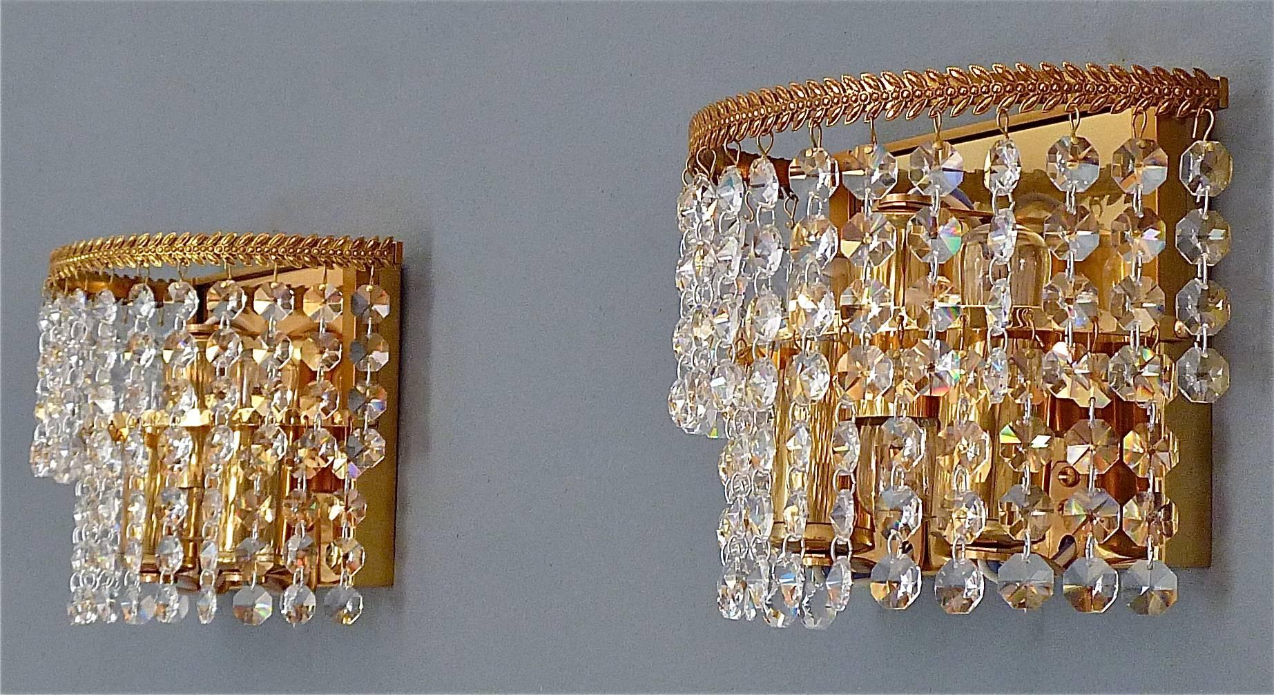 Pair of classical wall lights or sconces by Palwa, Germany circa 1960-1970. They are made of gilt brass and lots of sparkling faceted glass crystals with a classical leaf application to the rim. The elegant and chic model is typical for Palwa,