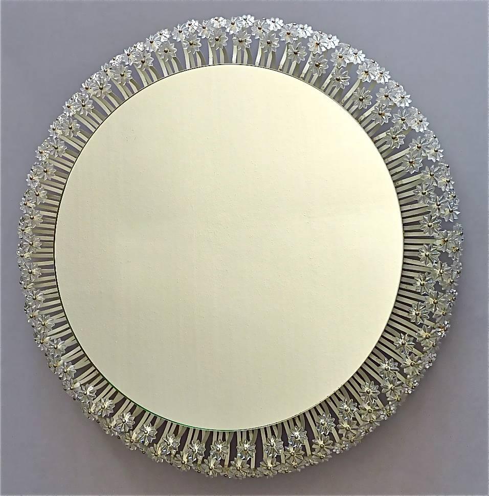 A beautiful large round flower wall mirror with illuminated background and hundreds of Lucite blossoms by Emil Stejnar for Rupert Nikoll, Austria. Fine working condition. Width 67 cm / 26.38 inches, 10 cm / 3.94 inches deep. This backlit mirror was