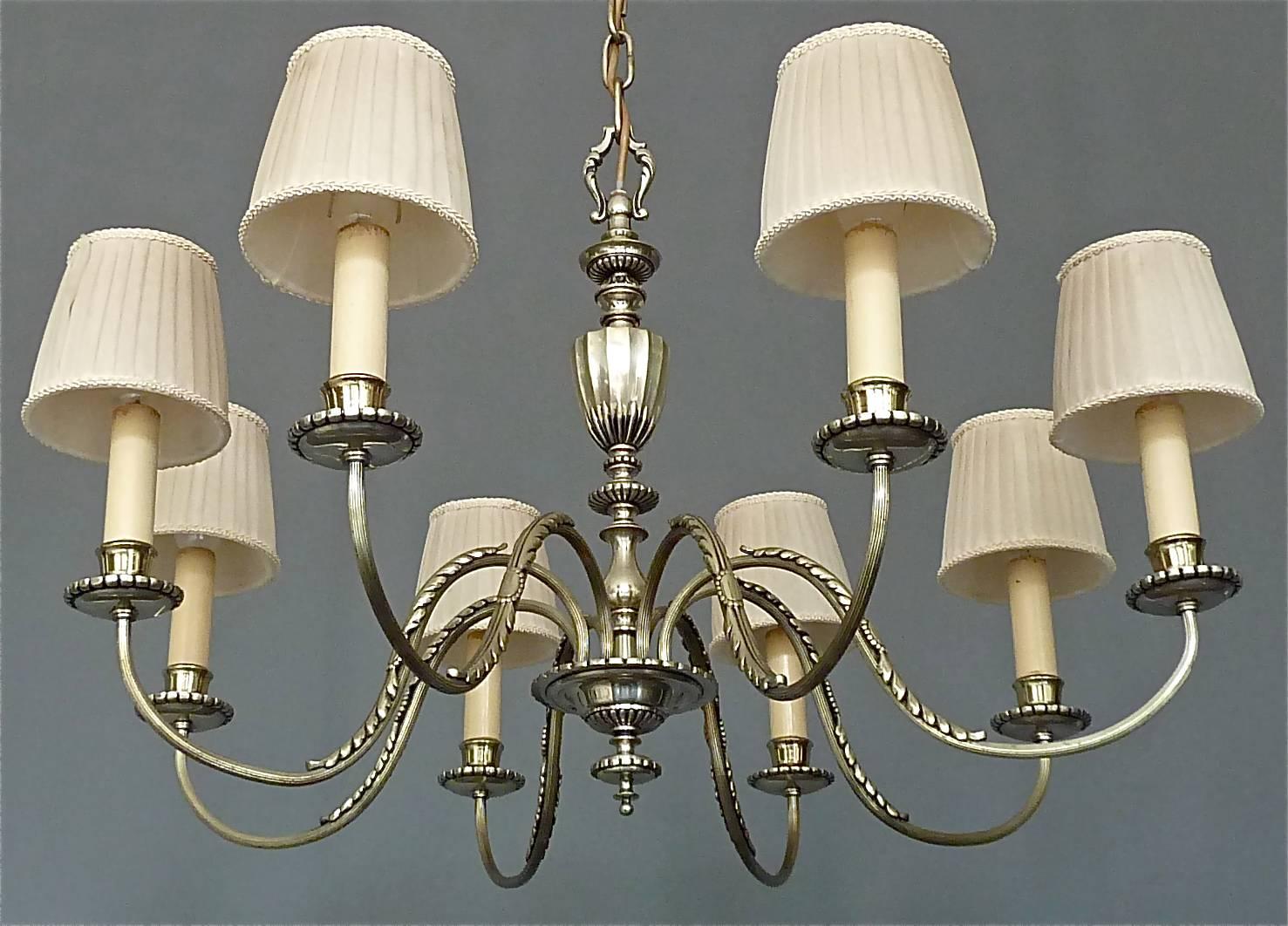 Elegant and fine classical Empire-style eight-light chandelier with original shades, France, circa 1920. The beautiful large chandelier with foliage motif on the arms and all-over lovely details is made of silver-plated brass metal with a nice and