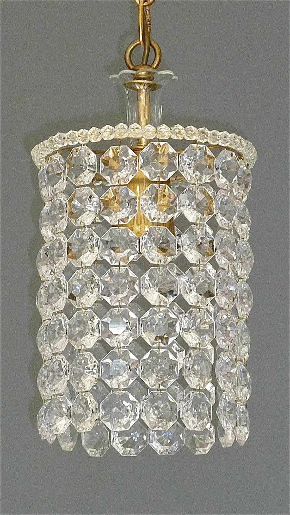 Precious petite midcentury chandelier made by the famous Austrian company Bakalowits, Vienna, Austria, circa 1955. The chain hanging height adjustable pendant lamp is made of patinated brass and lots of octagonal cut-glass crystal beads and pearls.