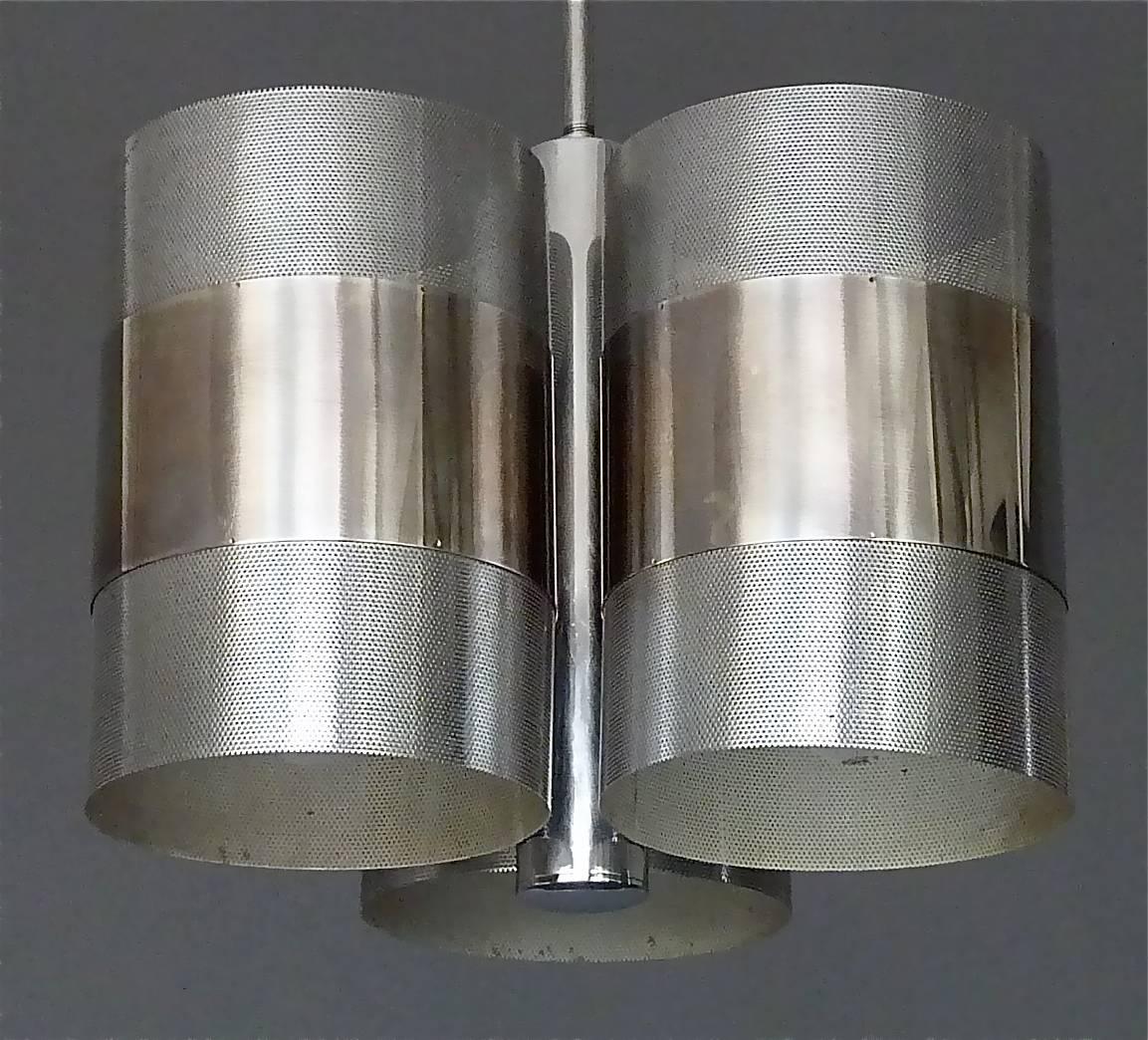 A modernist space-age perforated chromed stainless steel three tubes chandelier, France or Italy, circa 1968-1972. This fantastic pendant has three perforated chrome / nickel tubes with six E14 white plastic fittings for up- and down-light. Inside