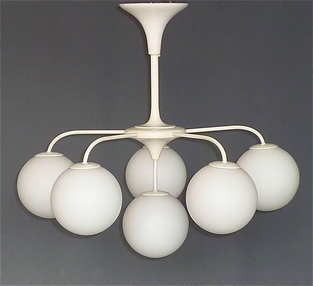 An early large sputnik chandelier by Max Bill, manufactured in Switzerland, circa 1955-1960, possibly by Temde Leuchten. This rare chandelier is made of white / off-white enameled wood and metal. It has a tulip shape aluminium canopy with a still