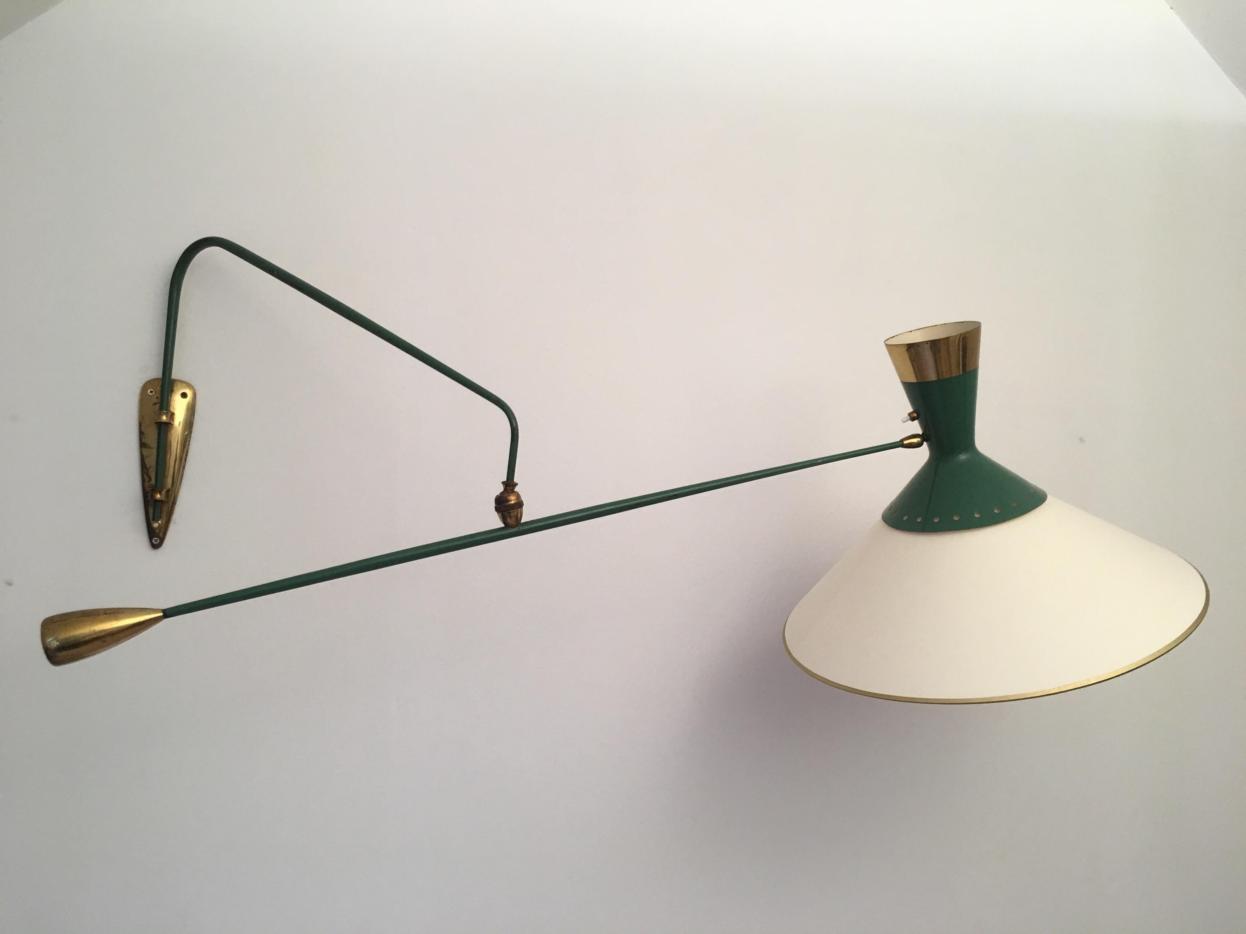 Rare green and gilt sconce designed by Maison Arlus in 1950's.
Two ball joint systems allow to place in all positions the second swing arm and the double metal diabolo reflector. 
The golden metal counterweight ensures the perfect balance.
A new