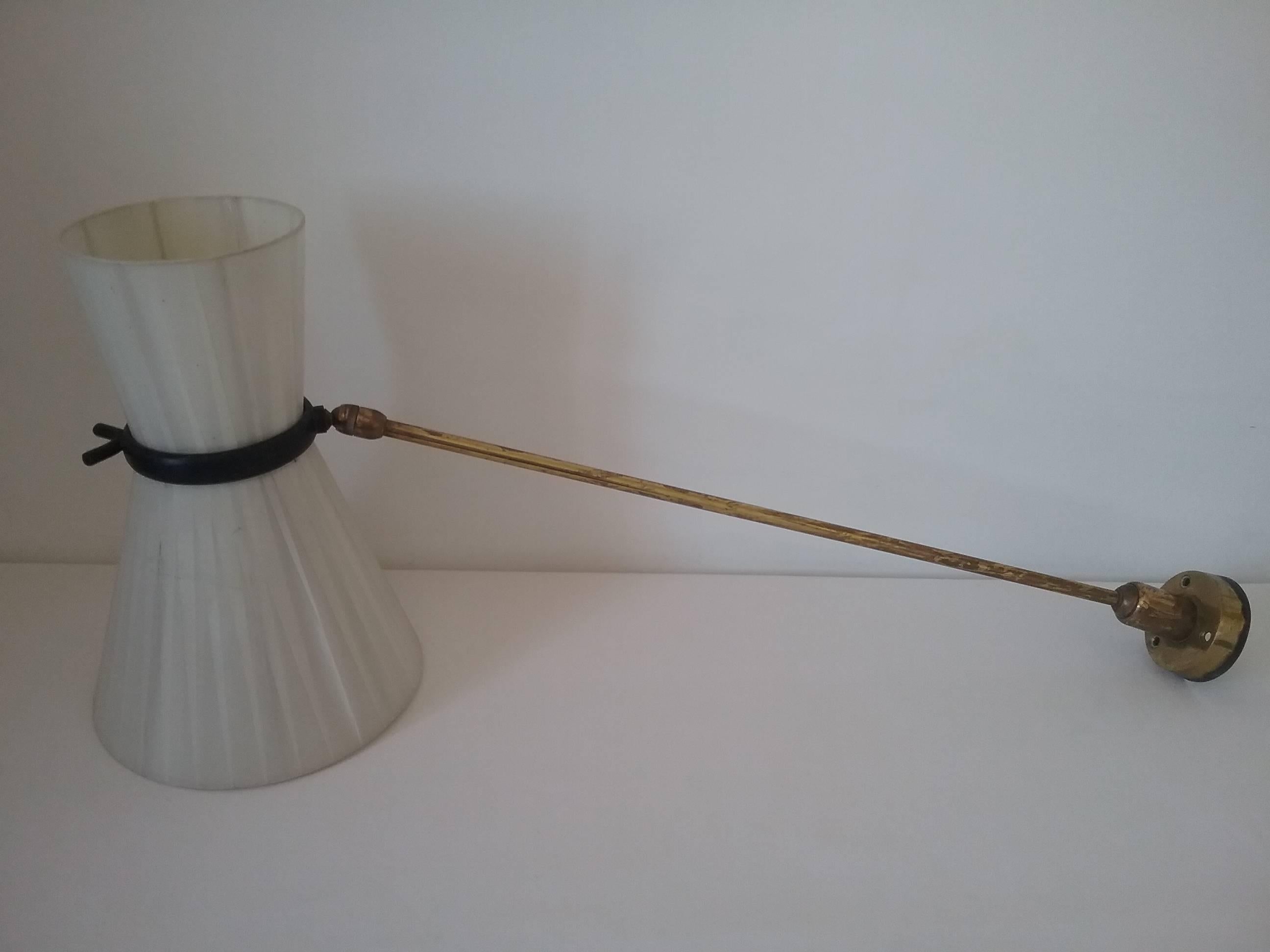 Very rare potence wall lamp with a swing arm mounted on an important ball-joint.
The arm may be turned in any direction. This is a typical lighting in 1950s
Original shade manufactured in fabric bands, some spots of use are present.
Vintage patina