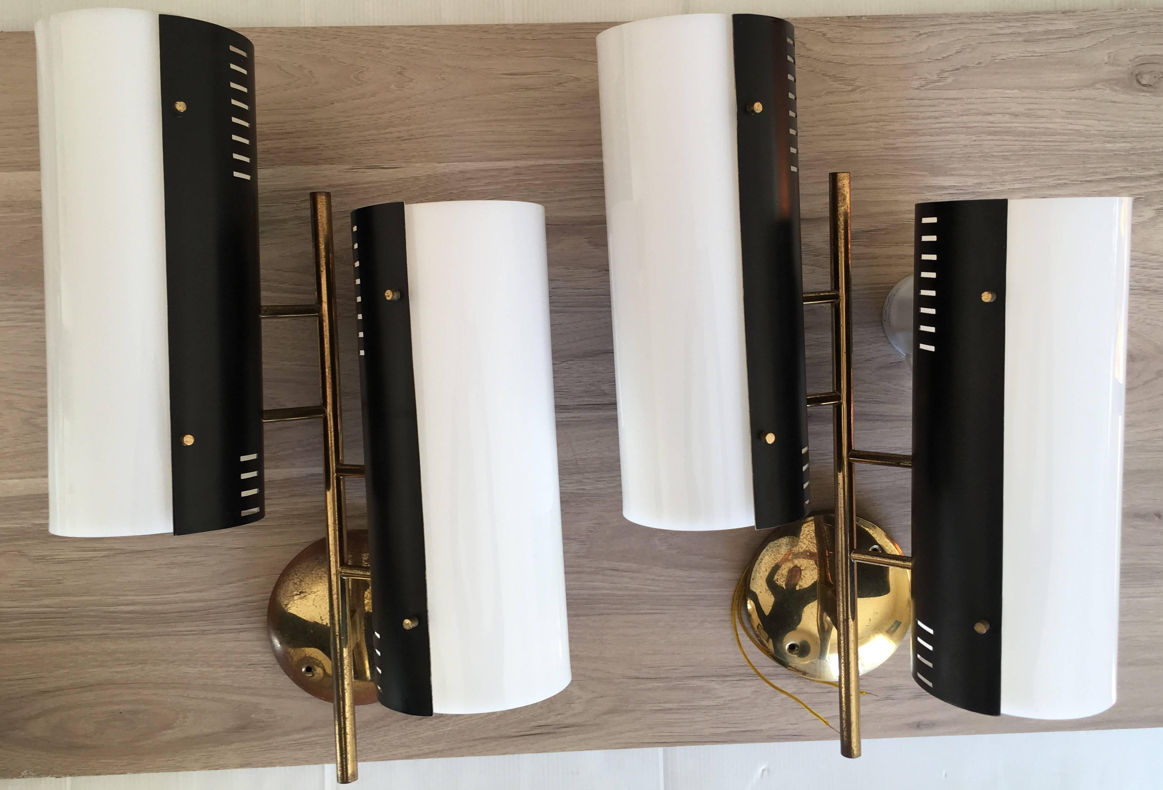 Modernist pair of wall lamps designed by Stilnovo Italy, circa 1950.
Gilded brass and black Lacquered frame with double white perspex sconces
Stilnovo label inside each black metal cylinder.
This large wall lamps size by Stilnovo is rare.
All parts