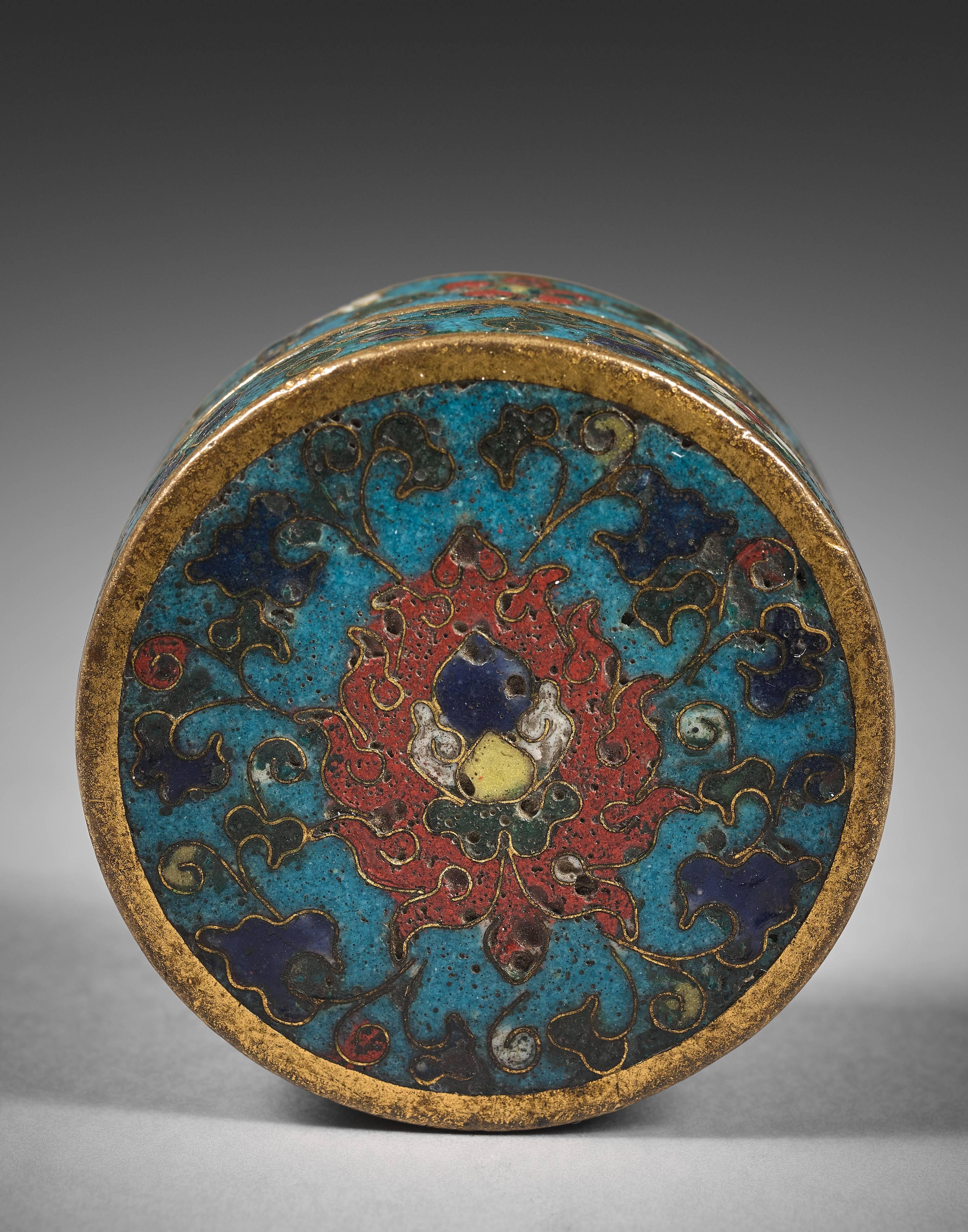 The circular-shaped box, decorated with red, blue, yellow, green and white cloisonné enamels. The lid decorated with a stylized lotus pattern and floral scrolls. The base and the inside gilded. 
From a Swiss Private collection

According to Brian