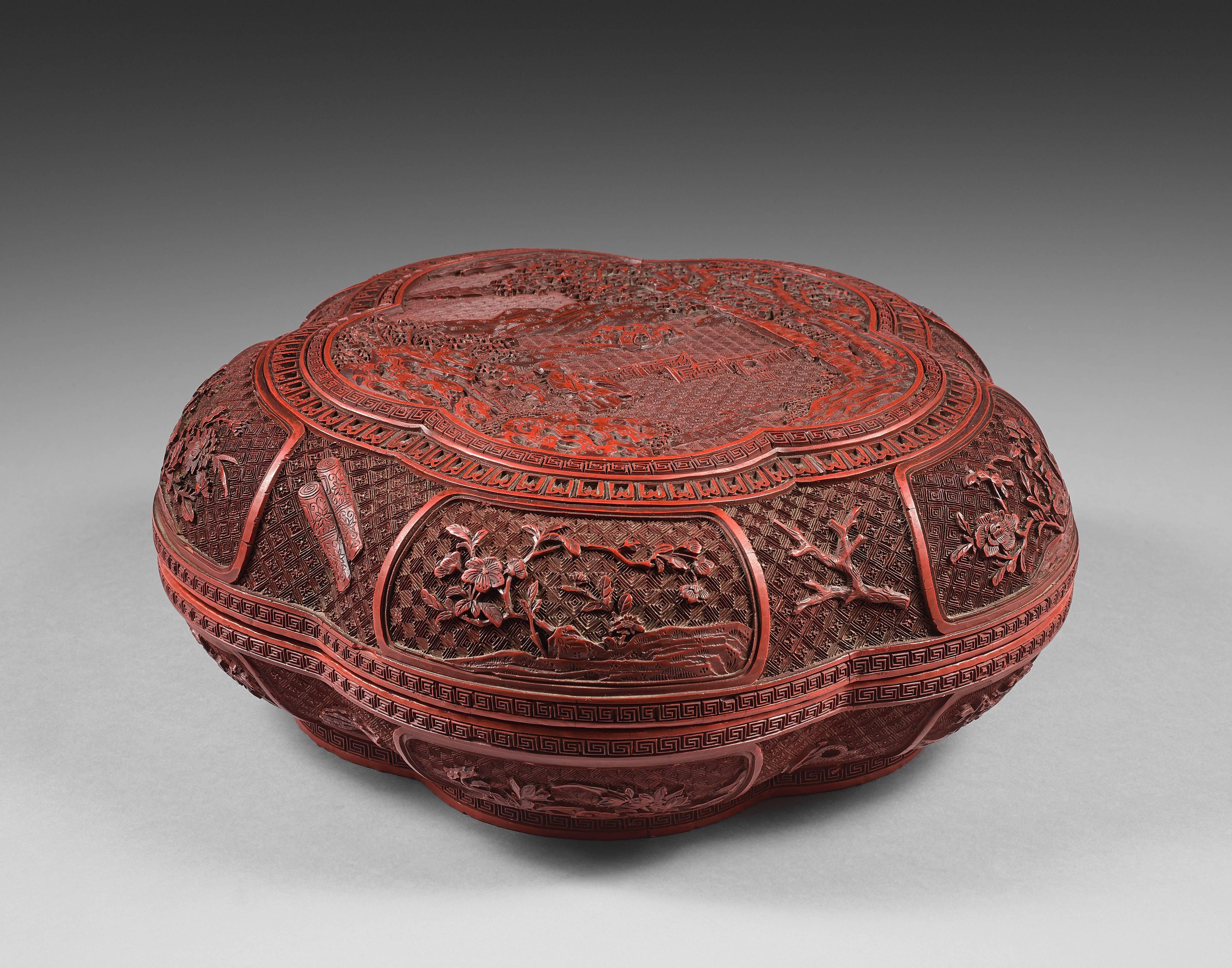 The box with a fully carved decor in multiple layers of lacquer. The lid, decorated in the center, with a polylobed medallion showing the painter Ni Zan in his garden, watching two of his servants washing a wutong tree, while a third servant stands