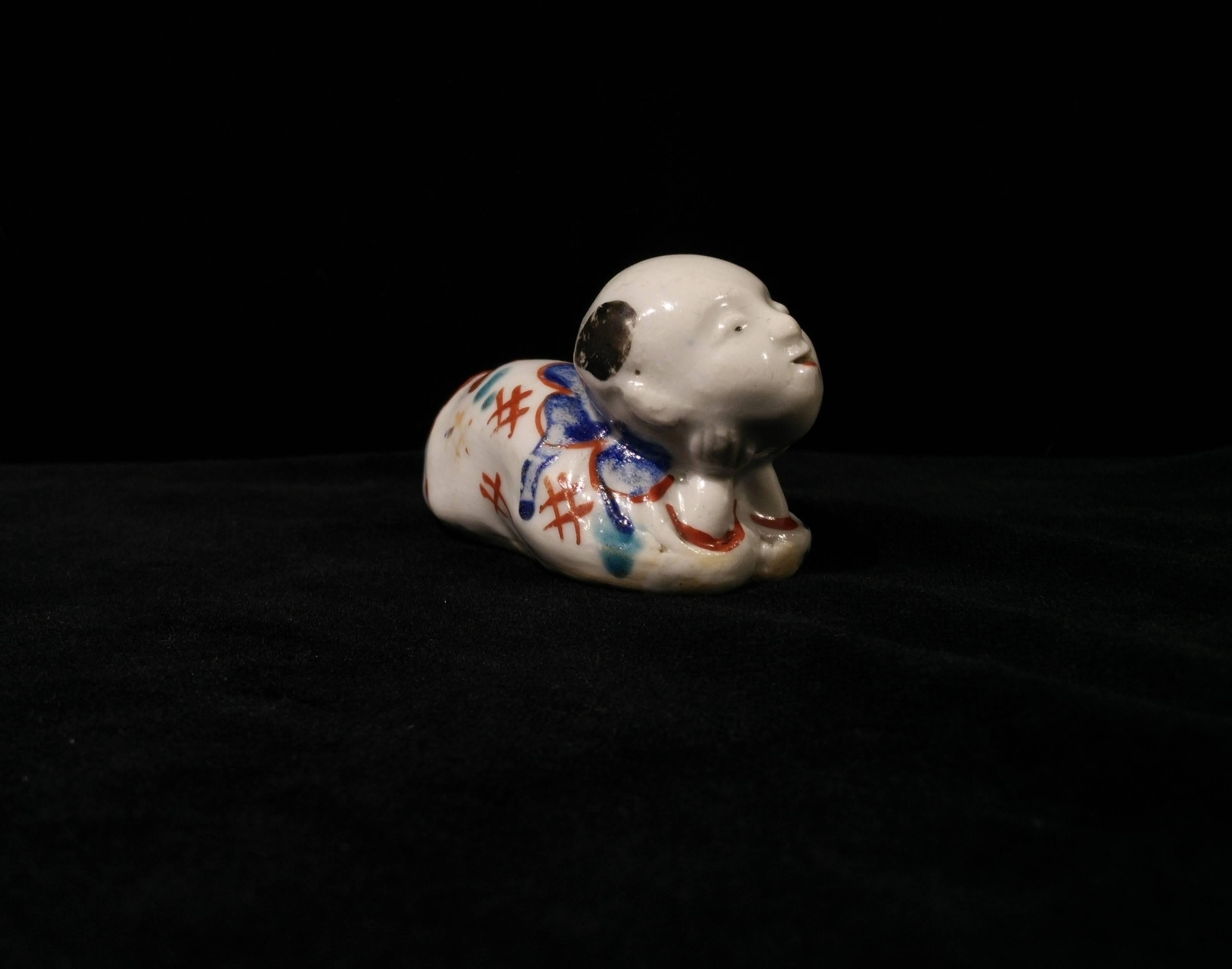 Glazed 17th Century Japanese Early Kakiemon Porcelain Small Boy Shaped Whistle For Sale