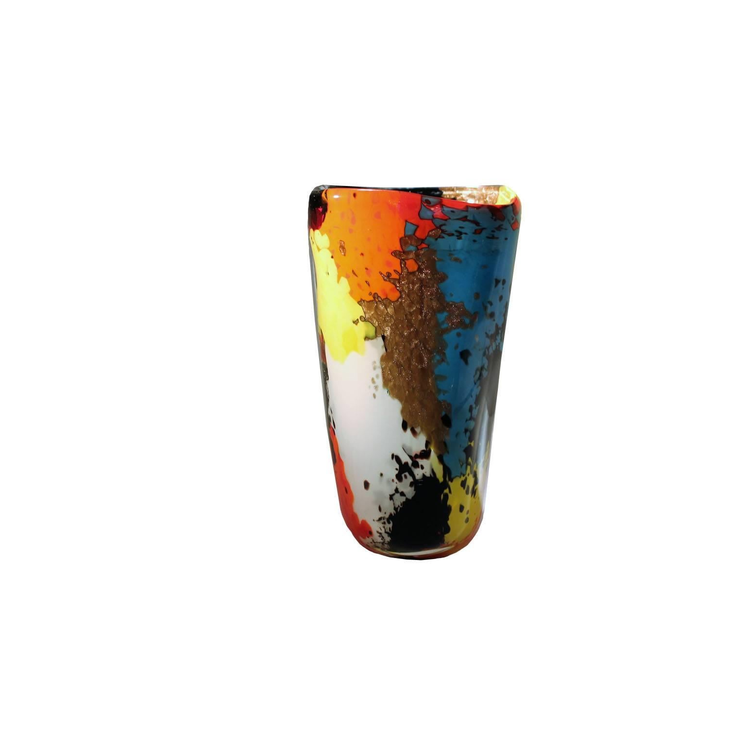 Designer Dino Martens. Oriente vase.
Made by Aureliano Toso, manufacturer.
Clear cased glass with powder inclusions in red, black, white, yellow, orange blue and aventurine; star-shaped murrine and translucent plates of different colors as well as