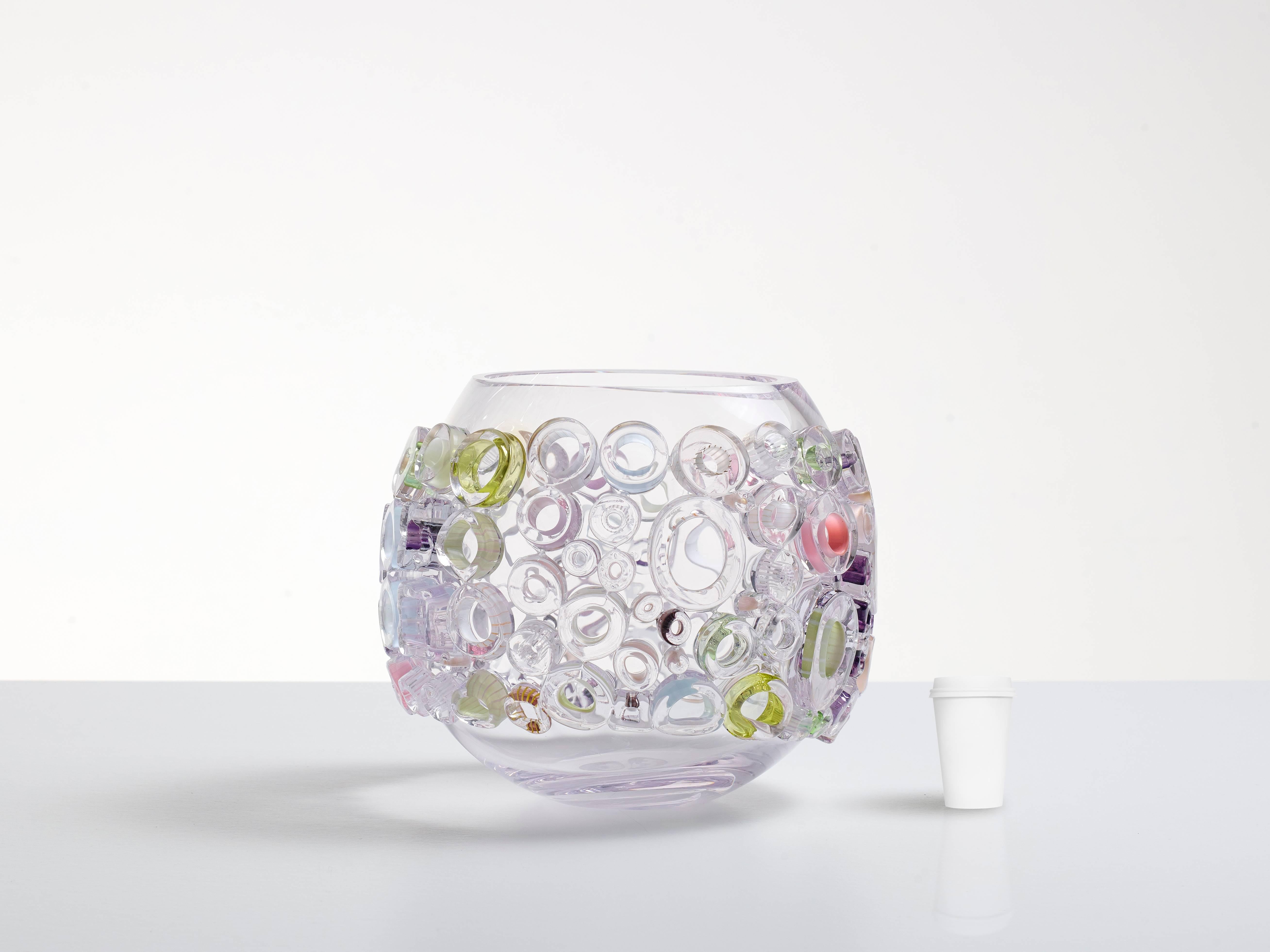 Blown glass bowl shaped sculpture. Translucent blown glass with glass ornaments melted to the body. The ornaments on the outside of the glass bowl contain subtle color applications in pastels like: pink, green, yellow, blue and purple. Each