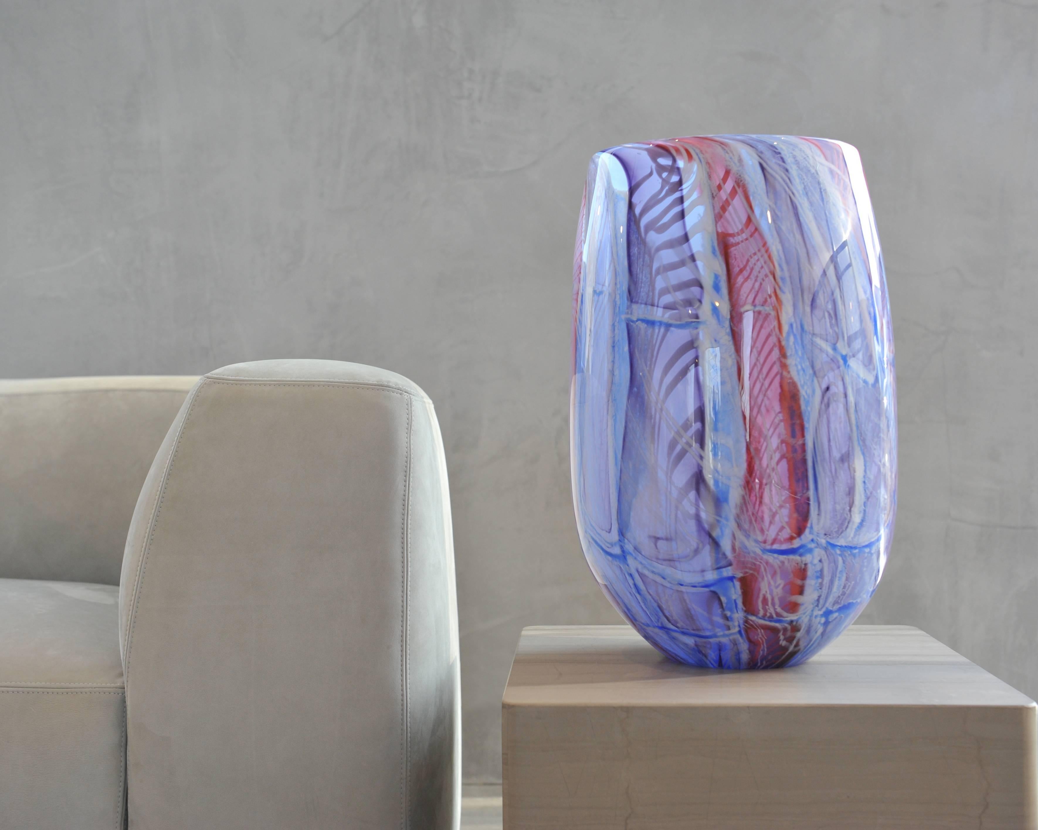 This beautiful blown glass tall vase created by glass artist Richard Price, is a jewel for the interior. Translucent color patterns are playing the eye. It is a unique piece that comes with a Certificate of Authenticity. Although it's a large vase,