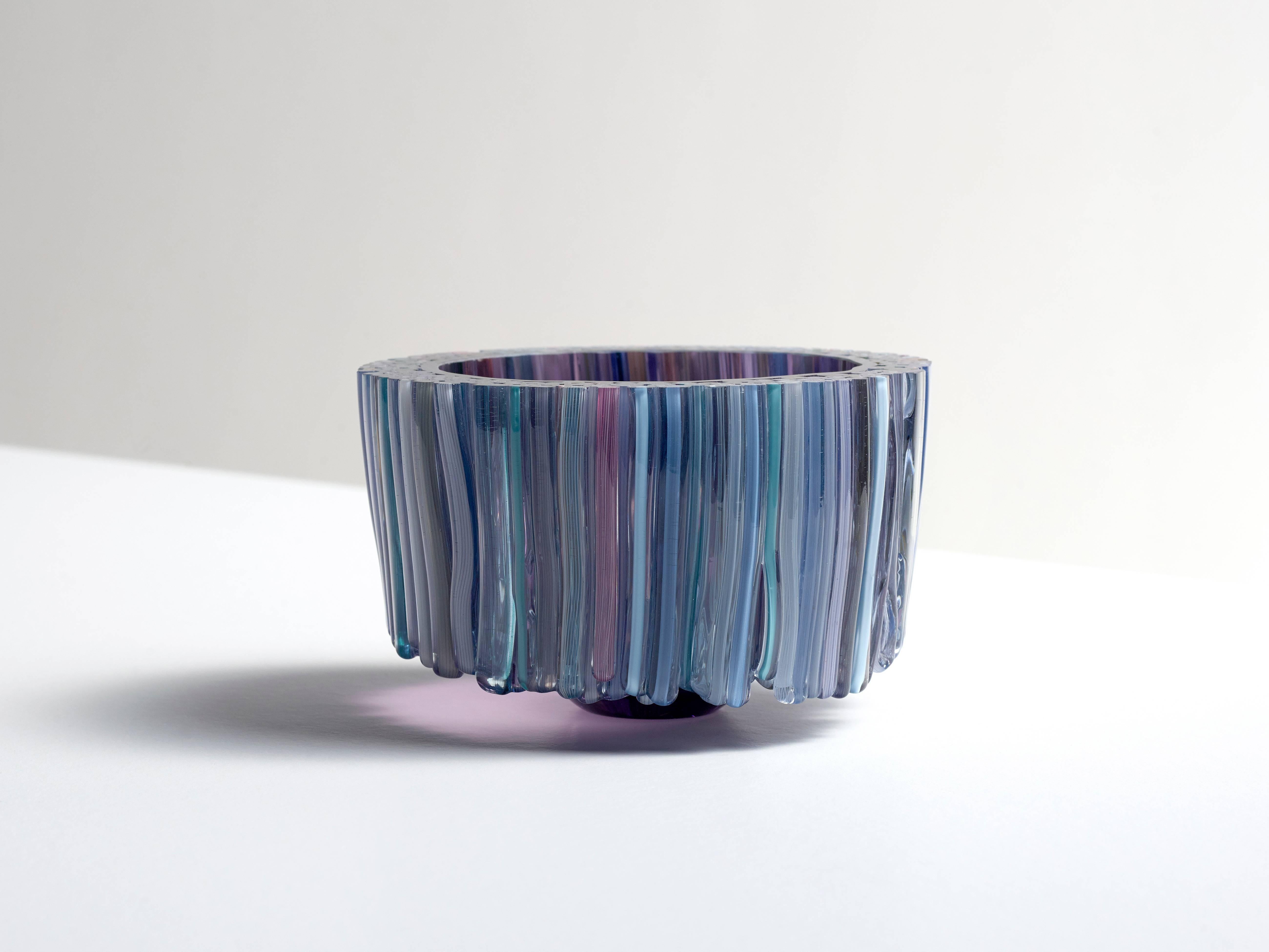 This beautiful blown glass blue bowl is decorated with handcrafted glass threads that are melted to the body of the glass bowl. The many colors of the threads like, blue, grey, white and pink are stylishly combined, resulting in a playful and