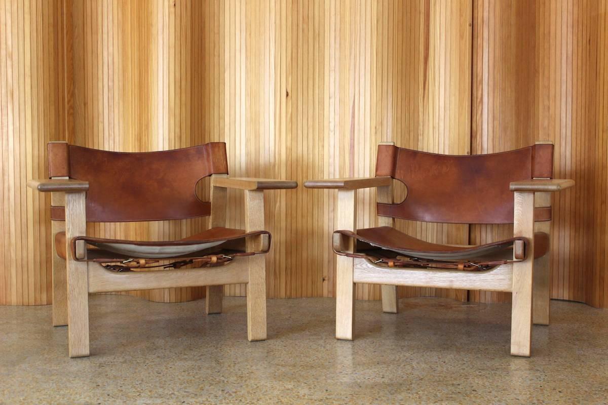 Rare and stunning pair of Borge Mogensen 'Spanish' chairs - manufactured by Fredericia Stolefabrik, Denmark. These are very early production examples. There are slight variations to the design.

1. The stitching detail is different there is a