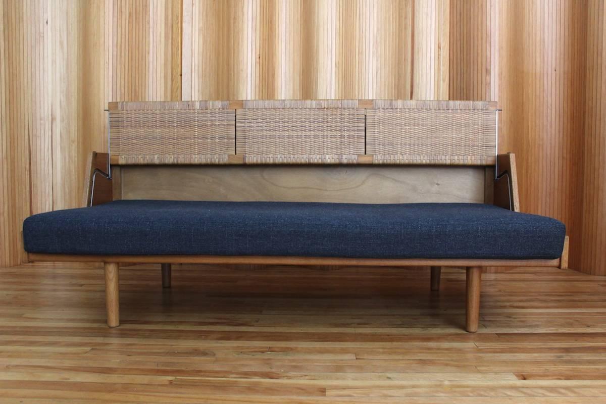 Oak sofa bed with rattan backrest and upholstered seat cushion - model no. GE-258 - designed by Hans J Wegner and manufactured by GETAMA, Denmark, 1954.

Excellent, vintage condition. The original rattan back is in great condition. The original