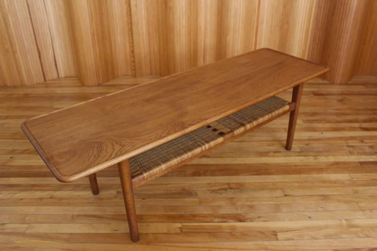 Description: Oak and rattan coffee table model no. AT-10

Designer: Hans J Wegner

Manufacturer: Andreas Tuck, Denmark

Date: 1950s

Dimensions: Length 161cm, depth 50.5cm, height 50.5cm.

Condition: Excellent, vintage condition. The solid