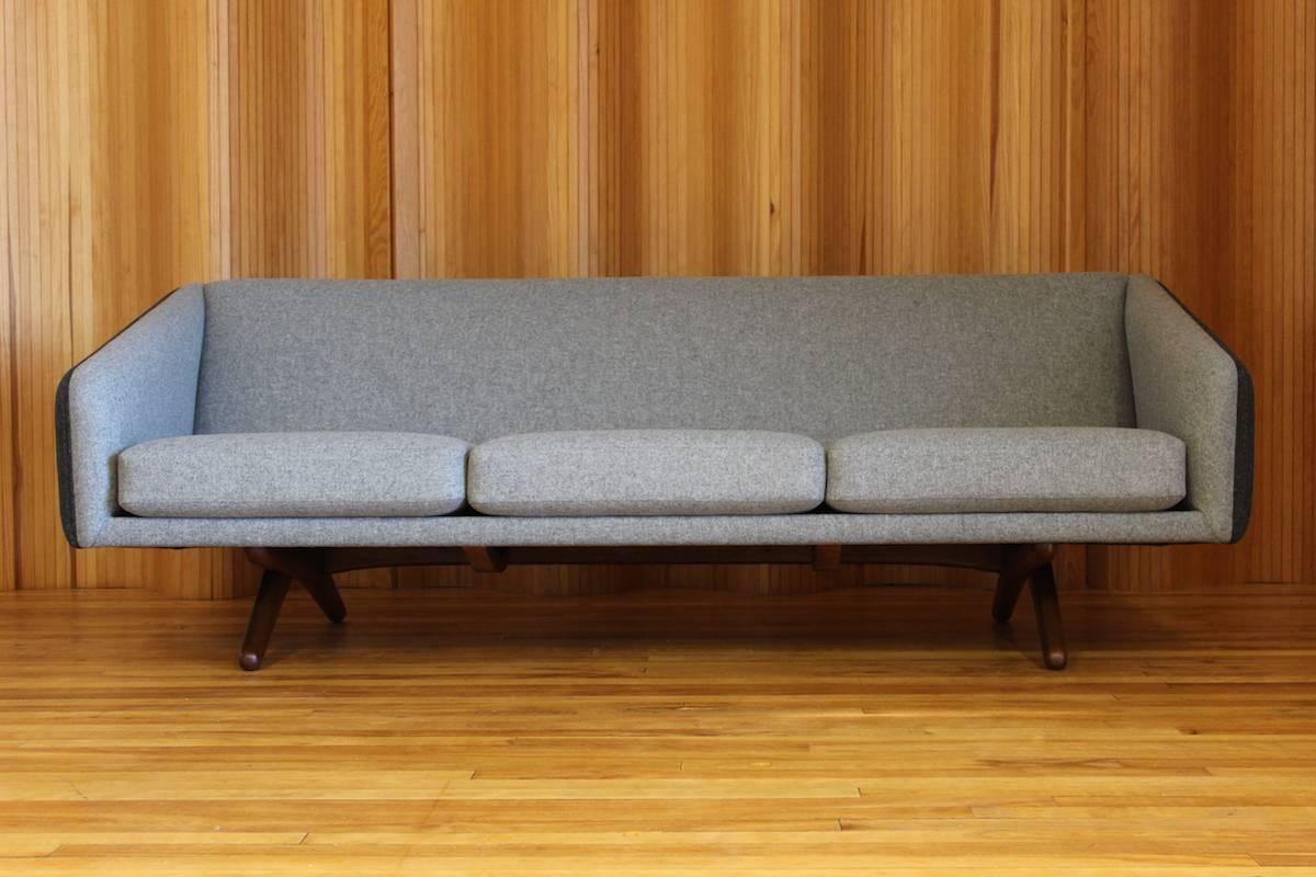 Stunning and rare Illum Wikkelsø three-seat sofa - model no. ML-90 - manufactured by Mikael Laursen, Denmark. This example has a solid teak leg frame. 

Original sprung seat cushions. The sofa has been re-upholstered in two tone Abraham Moon