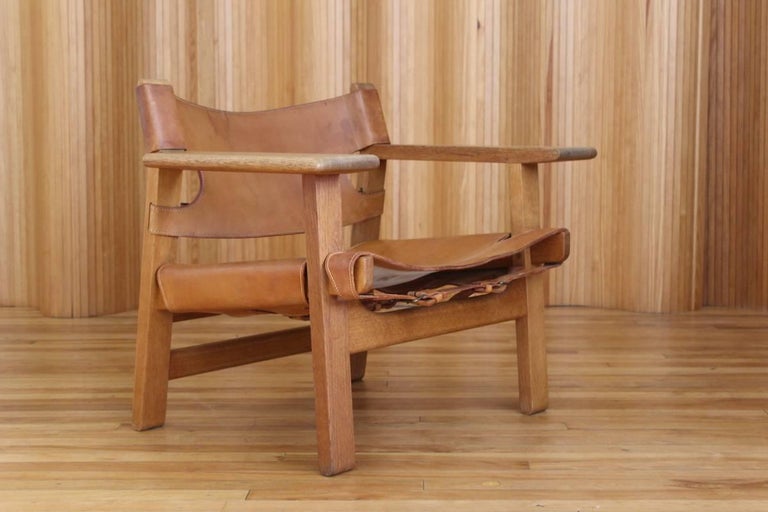 Description: Oak and leather 'Spanish' chair, model 226.

Designer: Borge Mogensen (1914-1972)

Manufacturer: Fredericia Stolefabrik, Denmark - remnant of original paper label to the underside (see photo).

Date: 1958

Dimensions: Width