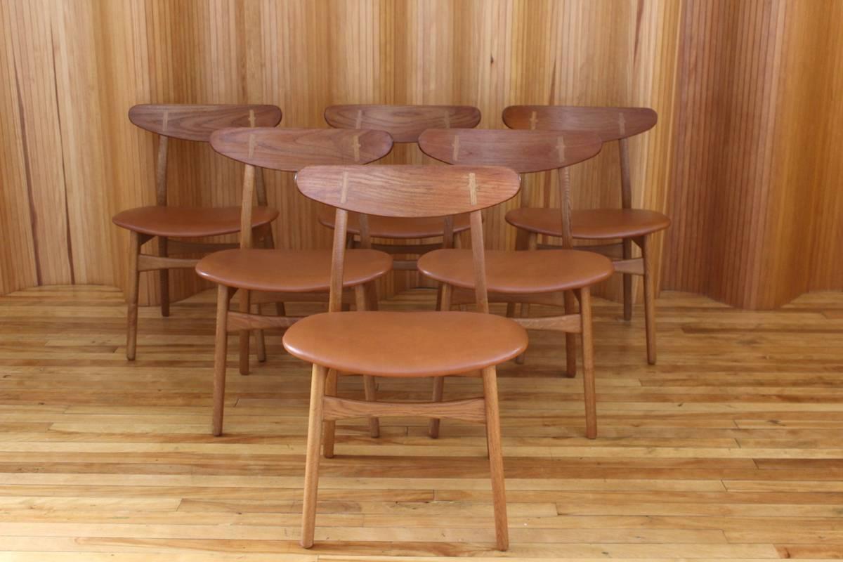 Description: Set of six oak and teak dining chairs, model no. CH30

Designer: Hans J Wegner

Manufacturer: Carl Hansen & Son, Denmark

Date: 1952

Dimensions: Width 52cm; depth 49cm; height 76cm

Condition: Excellent, vintage condition.